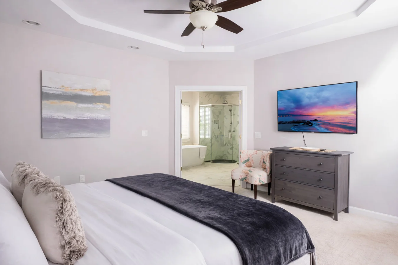 Master bedroom with king bed, coastal artwork, and ensuite bathroom at Suburban Sanctuary Retreat near Charlotte NC. Best Hikes Near Charlotte: 10 Trails Locals Actually Hike