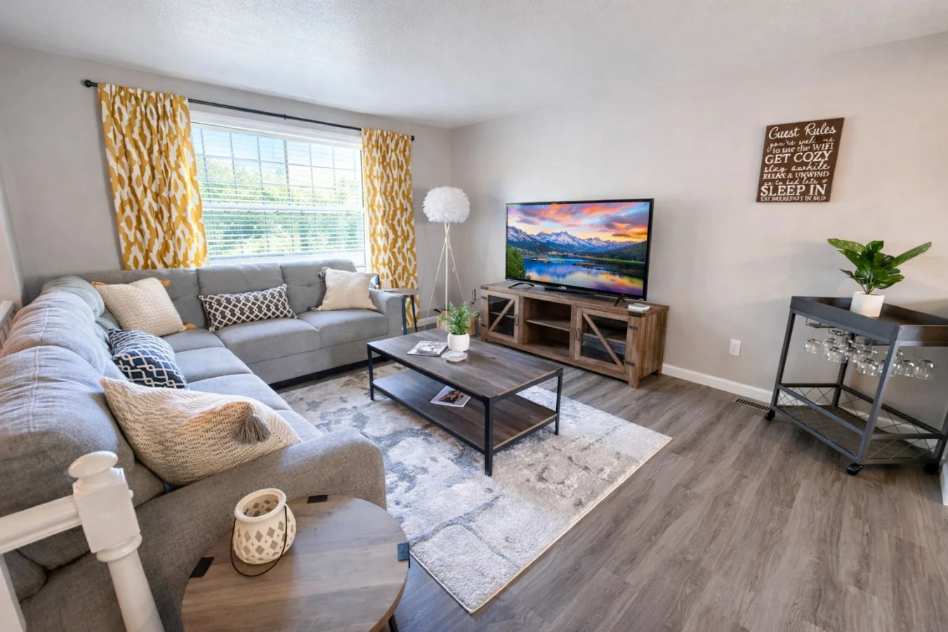 Gray sectional sofa and TV entertainment space in Charlotte vacation rental game room. Charlotte Vacation Rental Amenities Worth Paying For in 2026