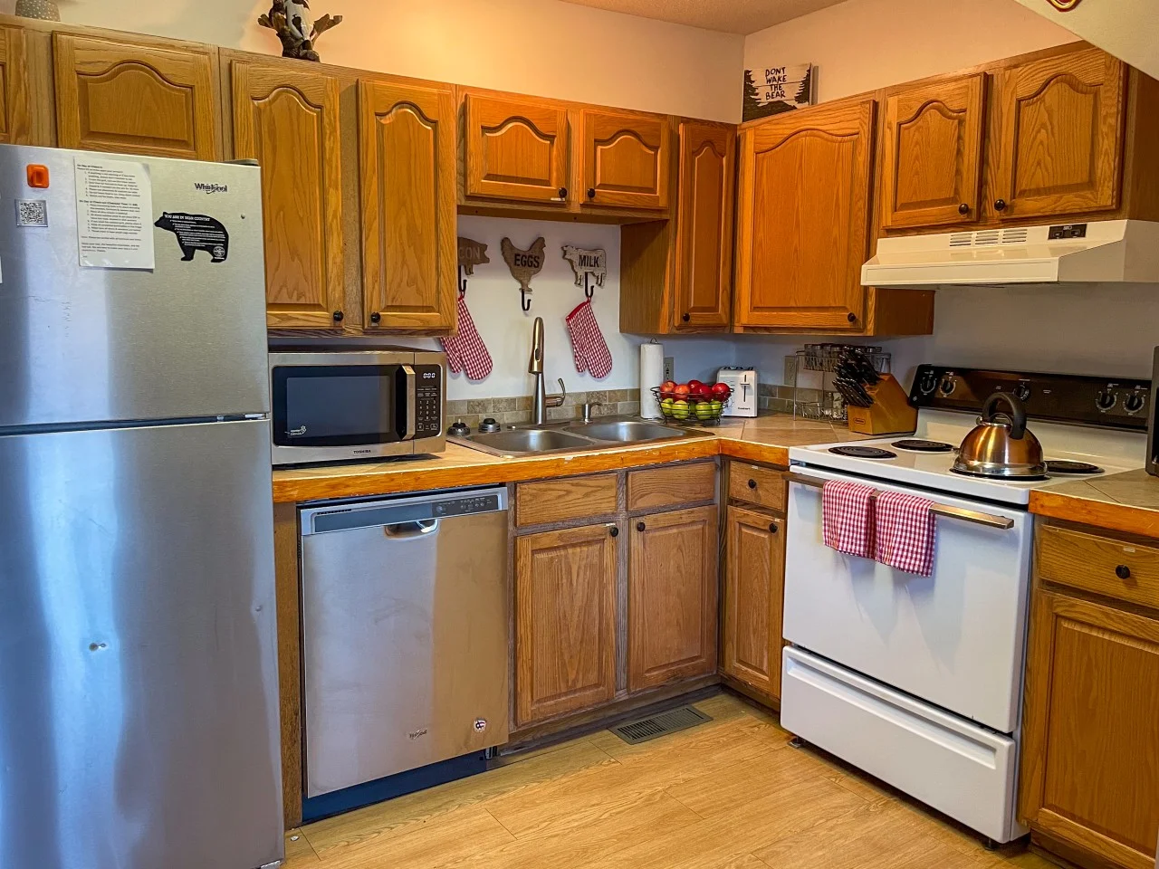 Rustic kitchen with wood cabinets and stainless appliances at Heavenly View in Gatlinburg, TN