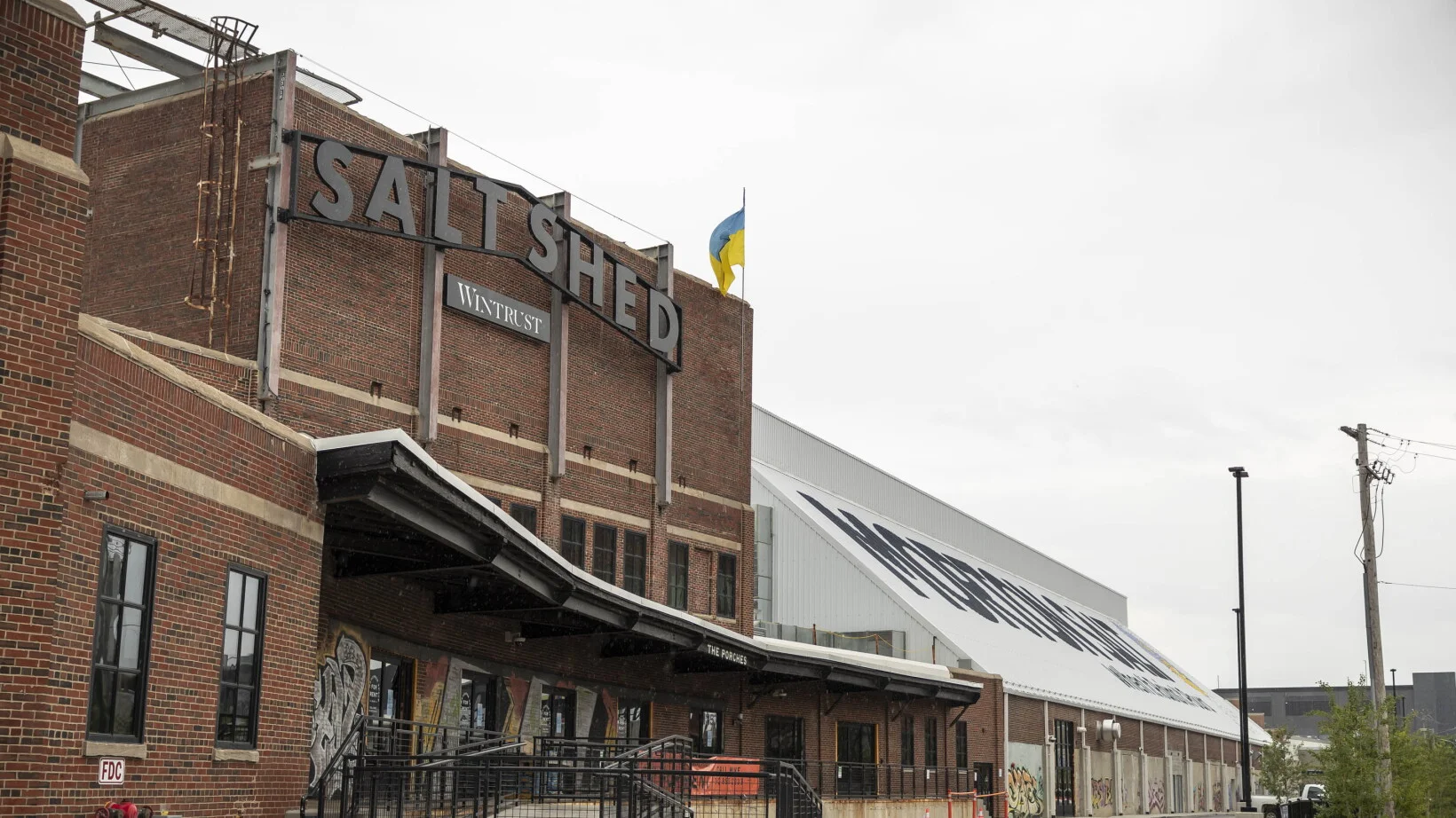 Historic brick building exterior with rooftop bar signage and industrial architecture in Chicago