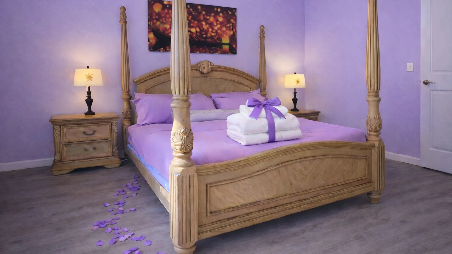Comfortable bedroom inside Davenport-area vacation rental with four-poster canopy bed and purple decor