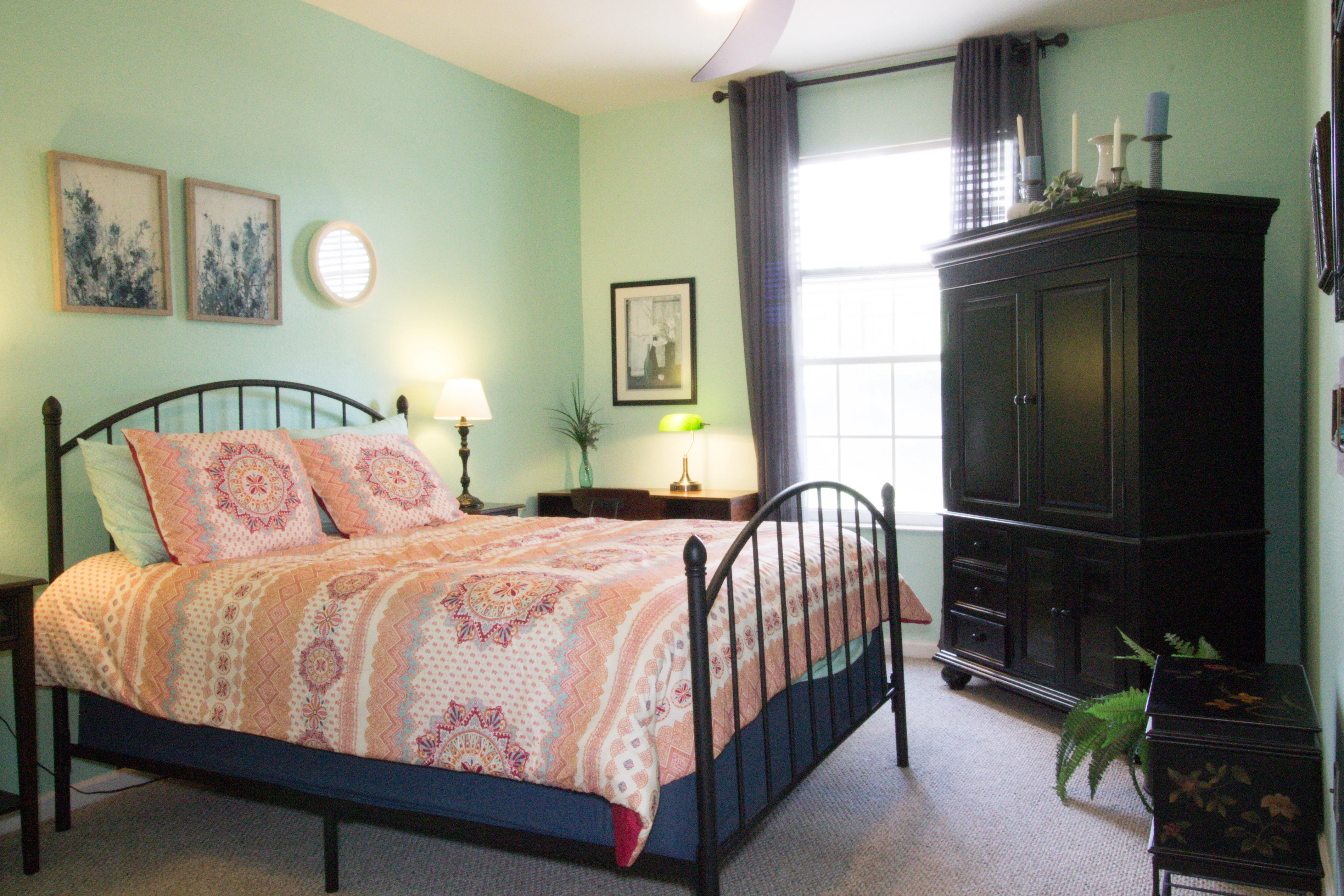 Spacious bedroom with mint walls and comfortable bed in Orlando FL vacation rental