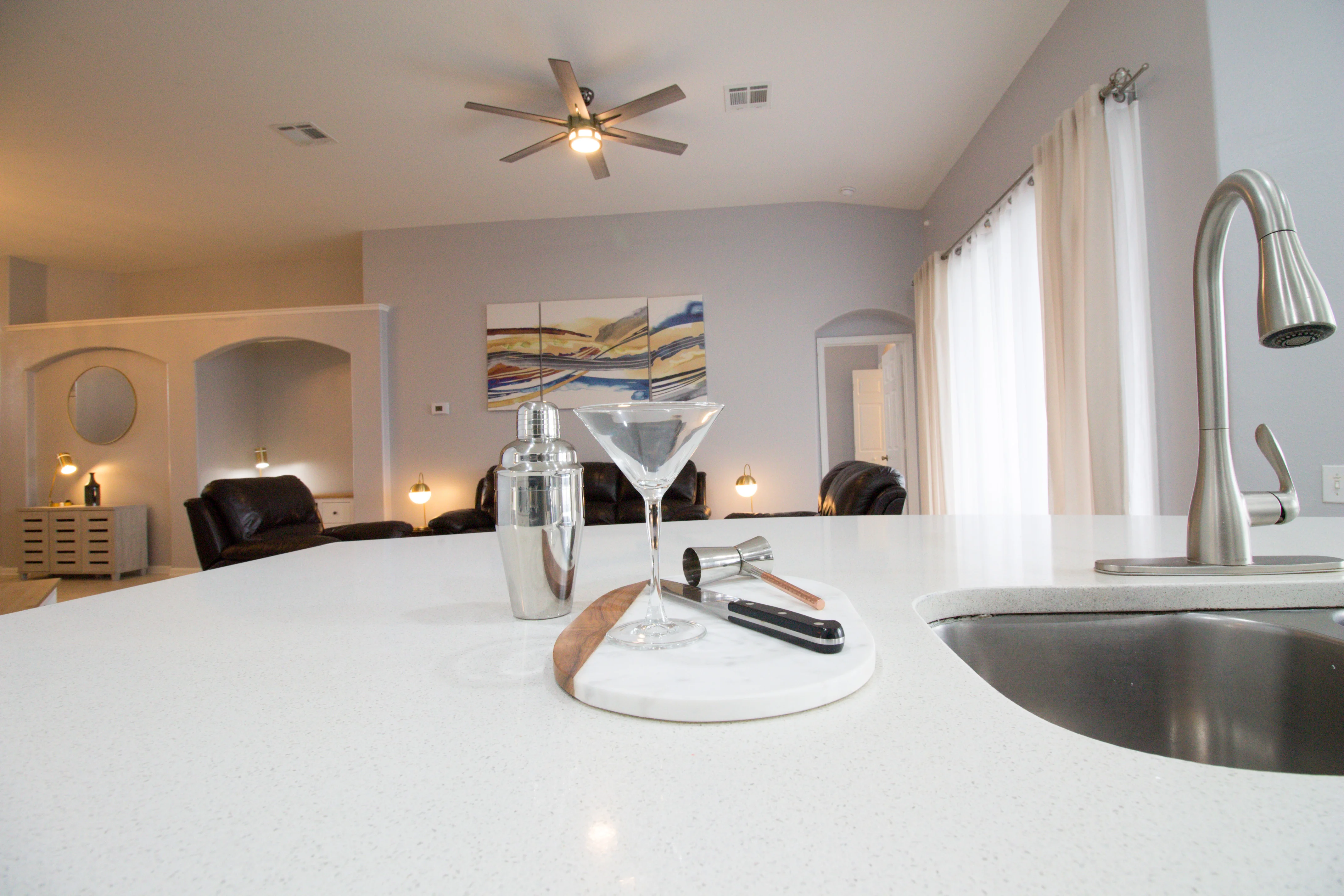 Modern kitchen with white quartz island and stainless steel appliances in Windsor Palms Orlando vacation rental