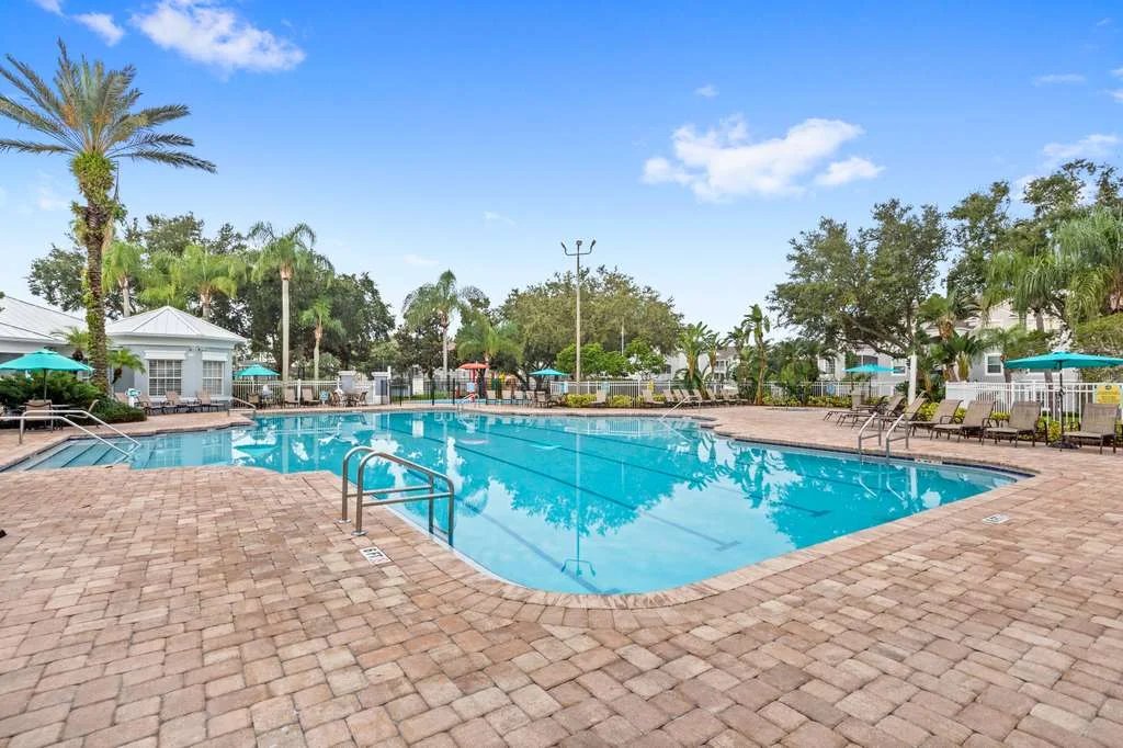 Resort-style pool with lounge chairs and palm trees at Windsor Palms vacation rental near Kissimmee Orlando