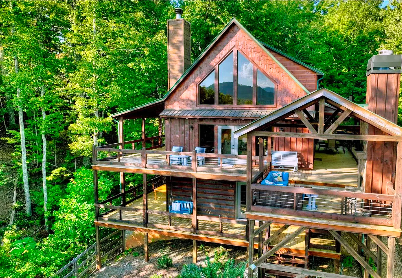 Log cabin bedroom with wooden bed frame and forest view in Blue Ridge GA cabin rental