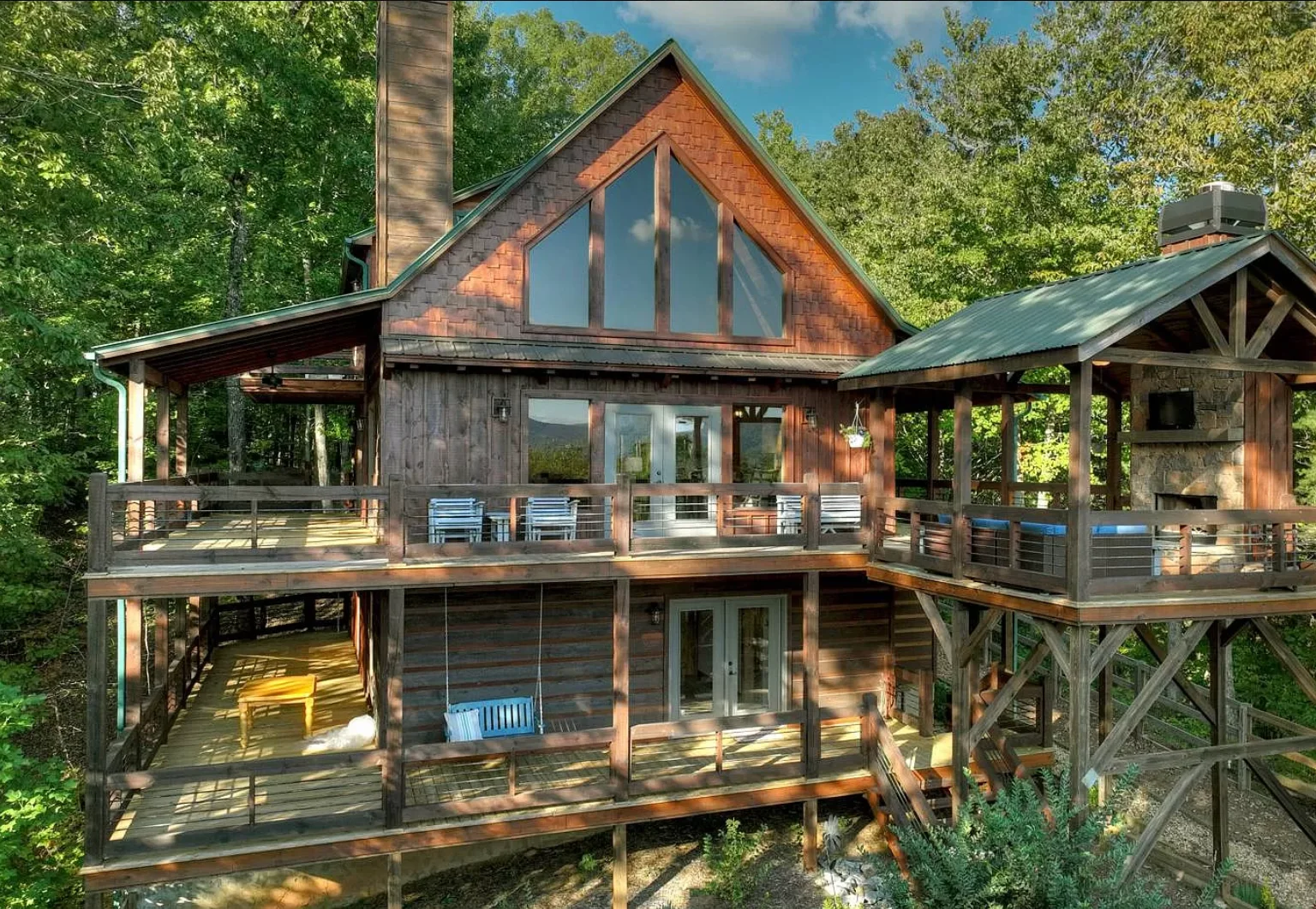 Rustic mountain cabin porch with wooden deck and forest setting in Blue Ridge vacation rental