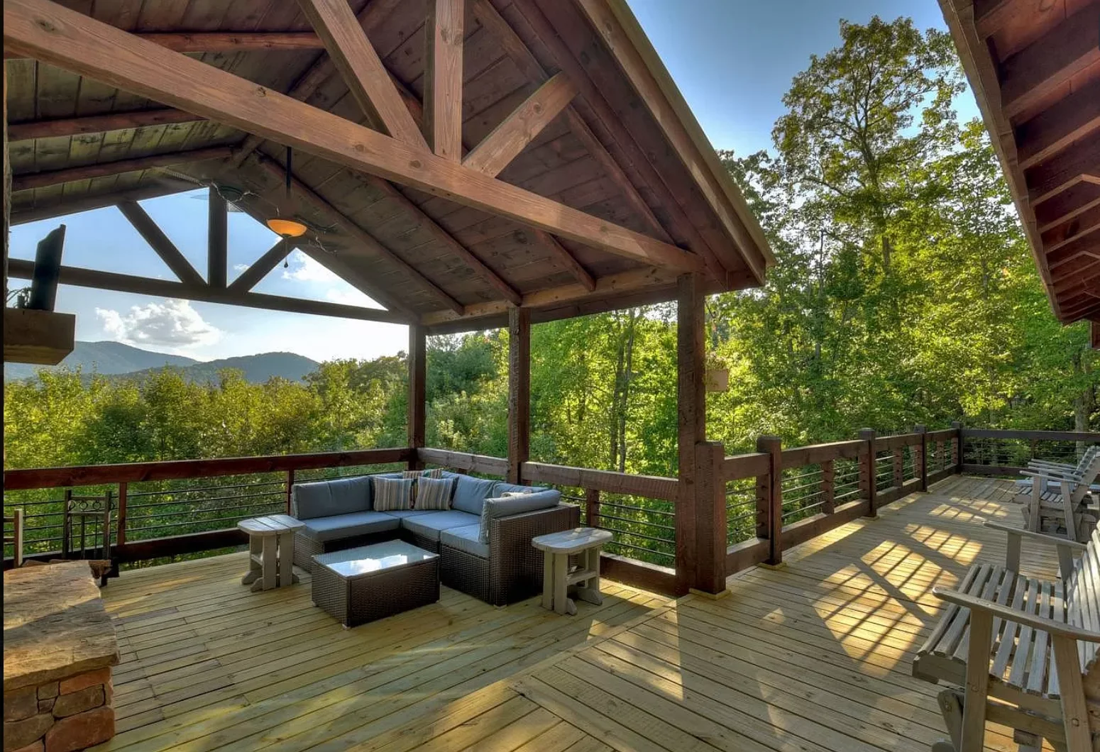 Modern chalet with red brick exterior, wooden decks, and mountain views in Blue Ridge GA