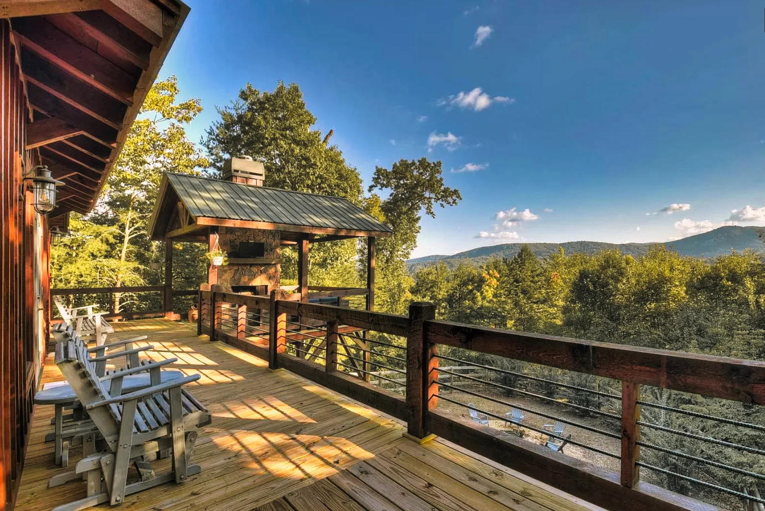Rustic bedroom with wooden beams and patio access overlooking forest in Blue Ridge cabin rental