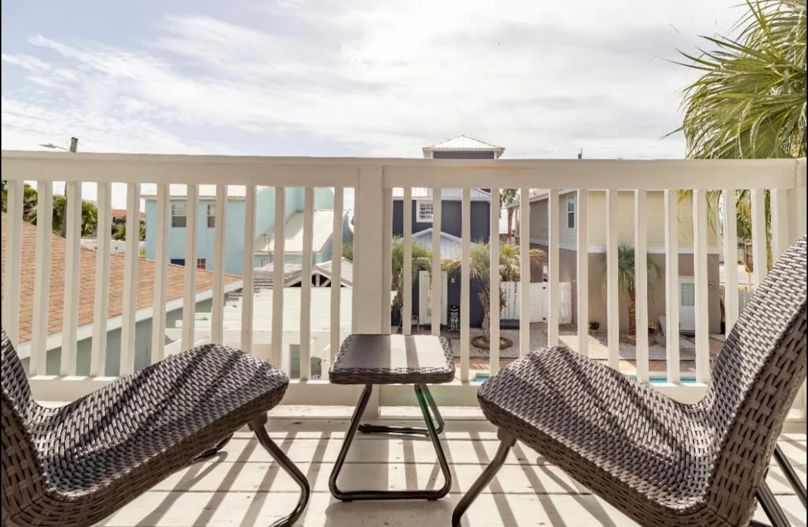 Beachfront balcony with lounge chairs and oceanview at Panama City Beach house rental villa near the beach