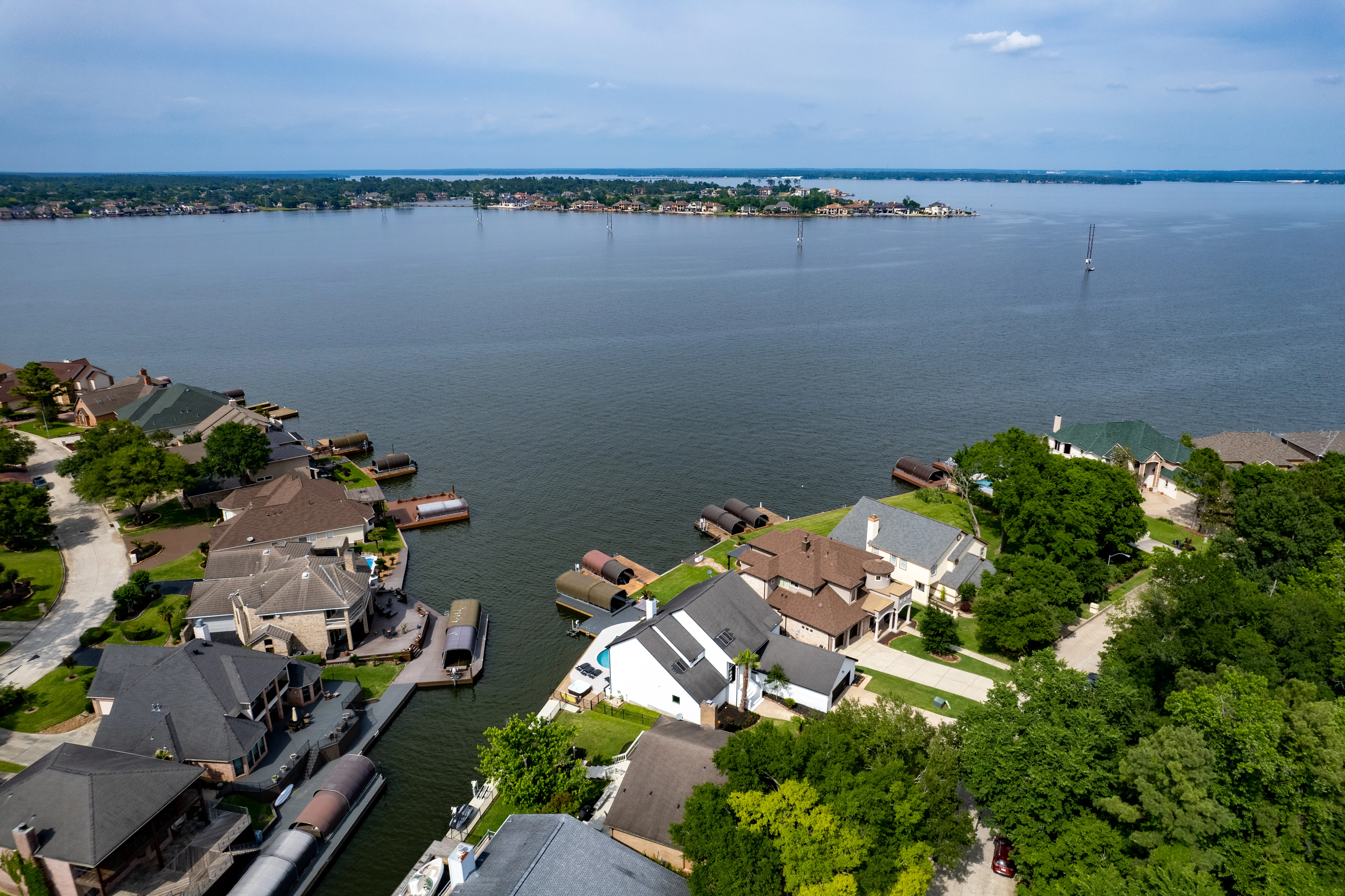 Aerial view of lakefront homes with private docks, a base for best pizza Montgomery TX trips