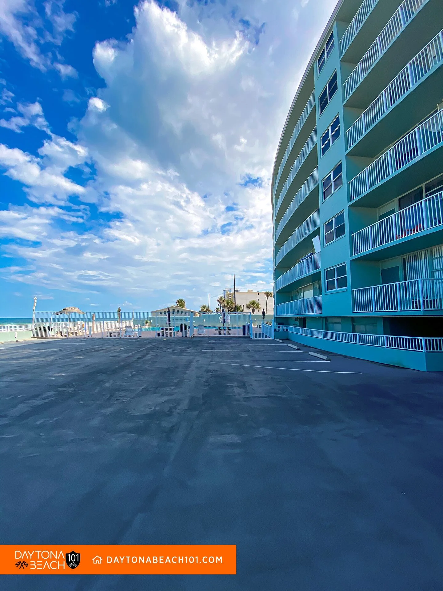 Beachfront condo building with turquoise balconies and oceanfront deck overlooking Atlantic Ocean in Daytona Beach