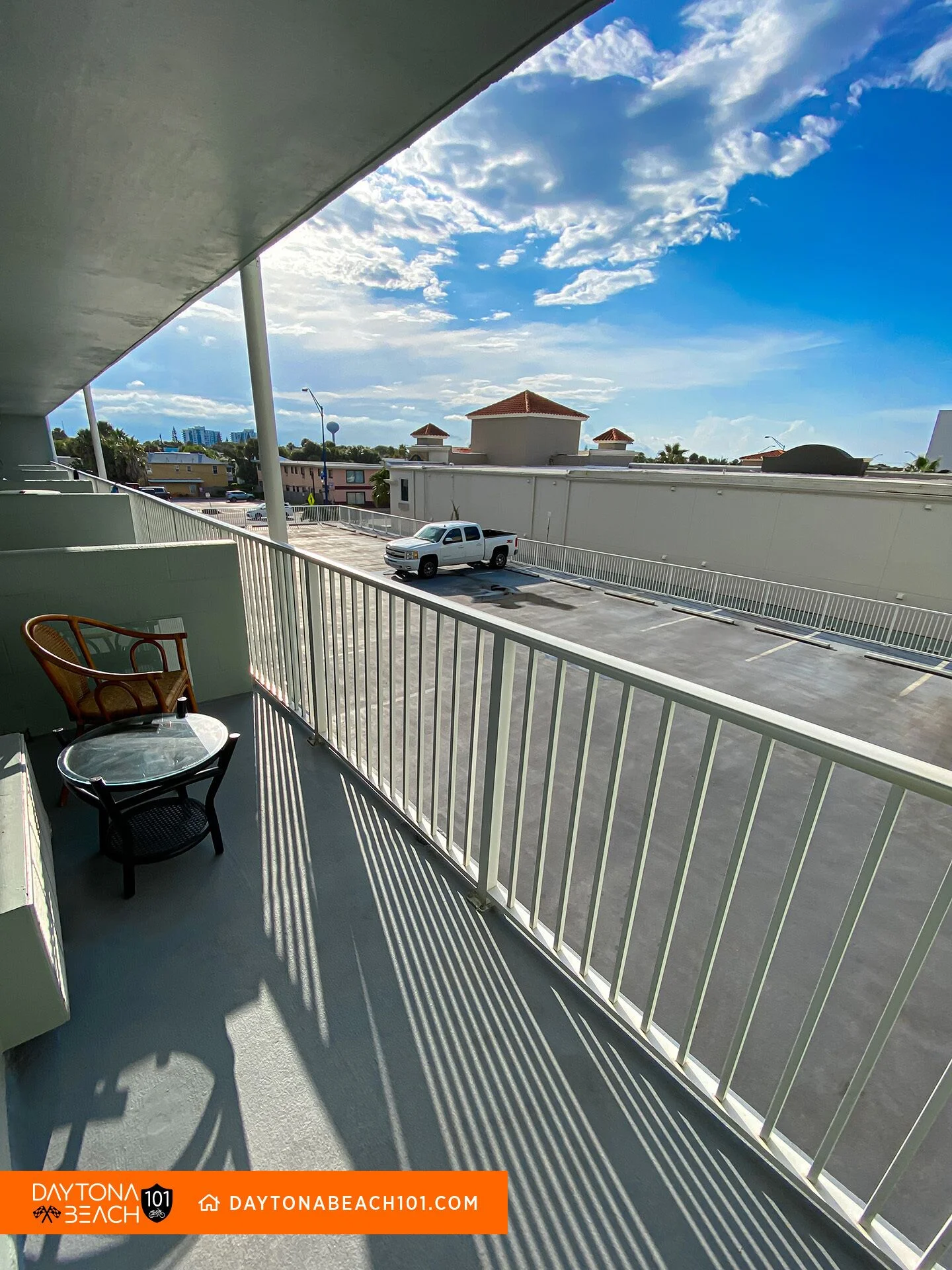 Covered oceanfront patio with white railings and elevated views in Daytona Beach rental property