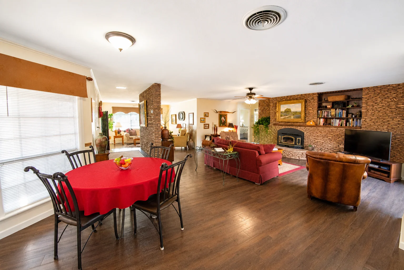 Open-concept living room with brick fireplace, a cozy base for teen friendly activities in Georgetown TX