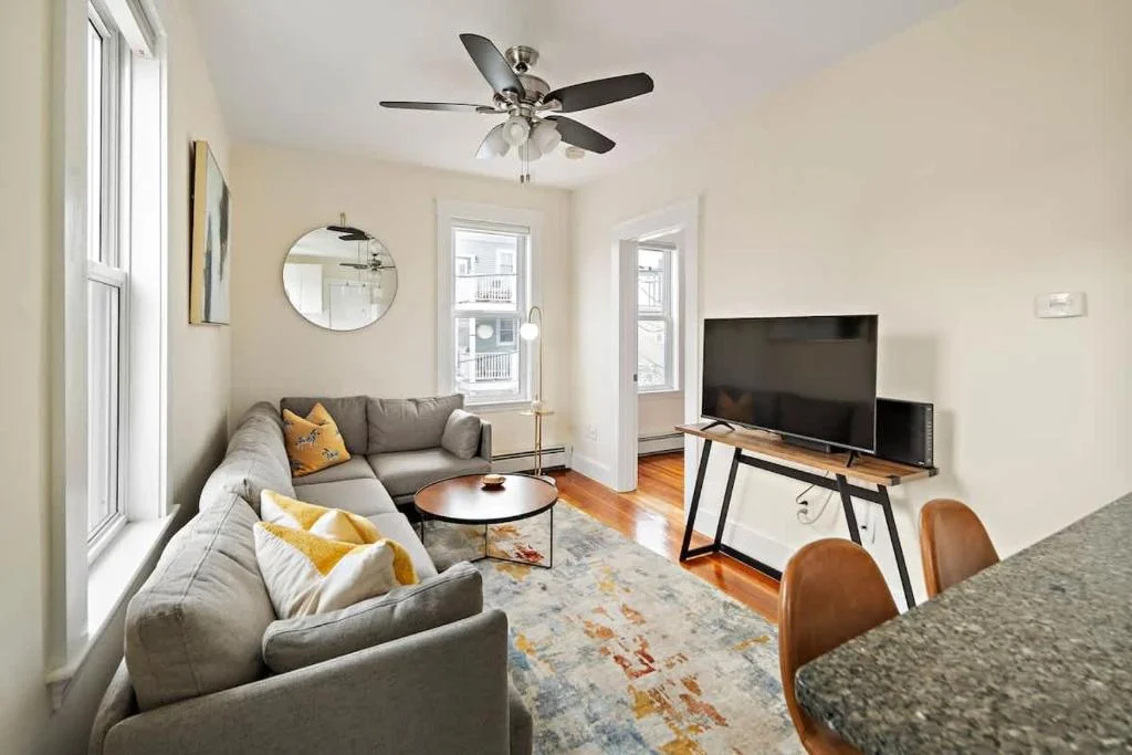Bright living room at 10 Porter Street, a listing photo example for Airbnb management in Cambridge