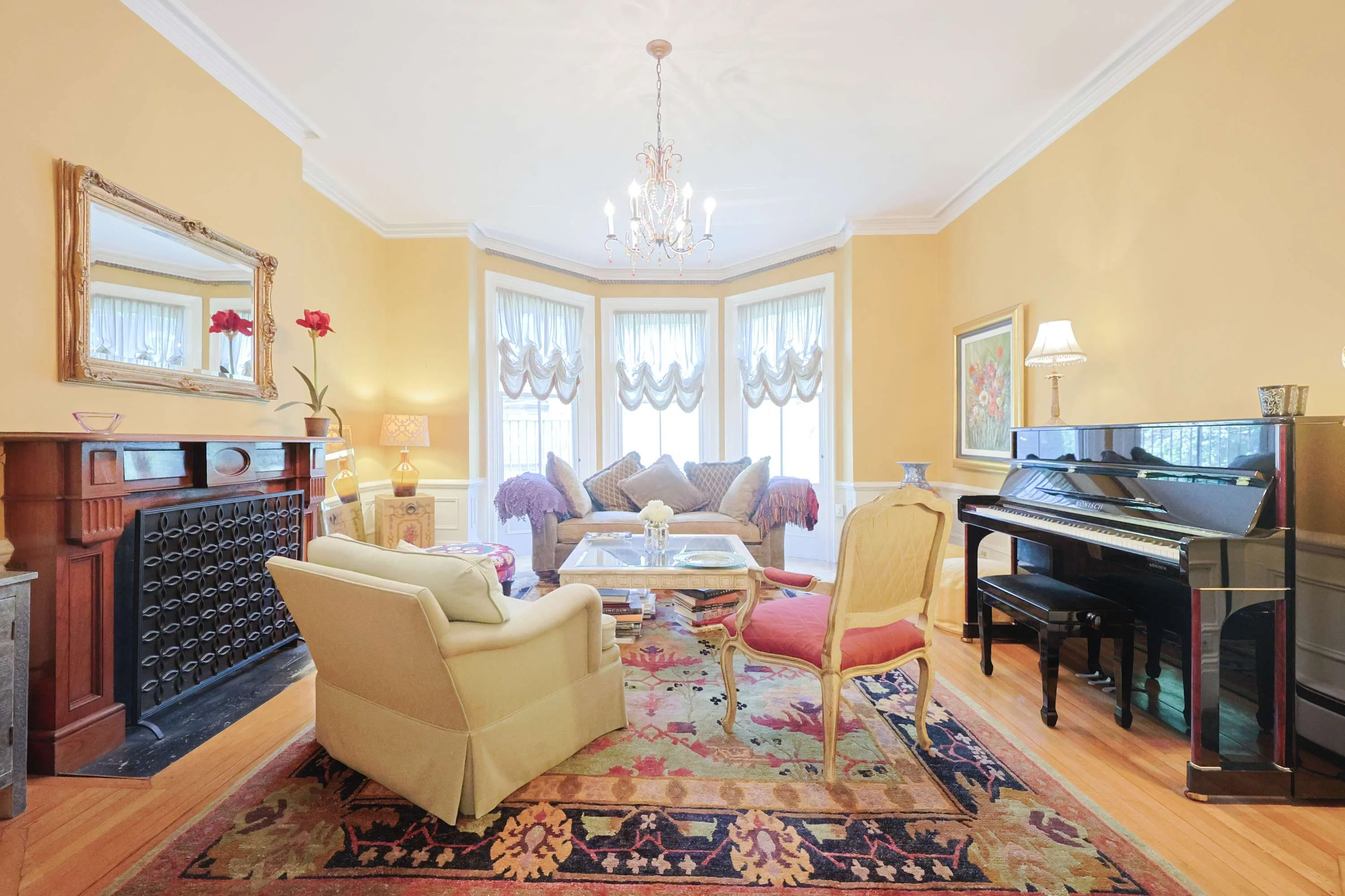 Elegant Boston brownstone living room with grand piano and fireplace, perfect for rainy day indoor activities