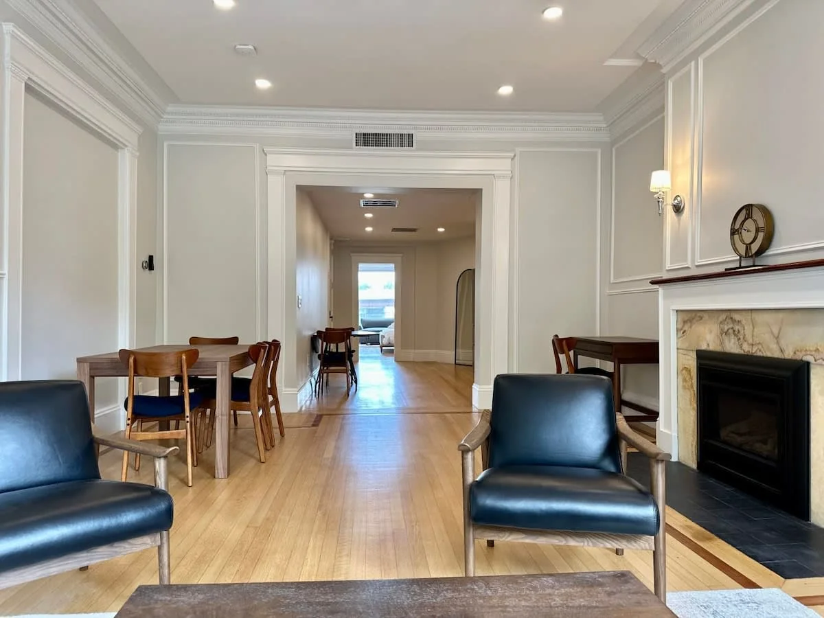 Professional photography of spacious living room with fireplace and open floor plan in Boston rental