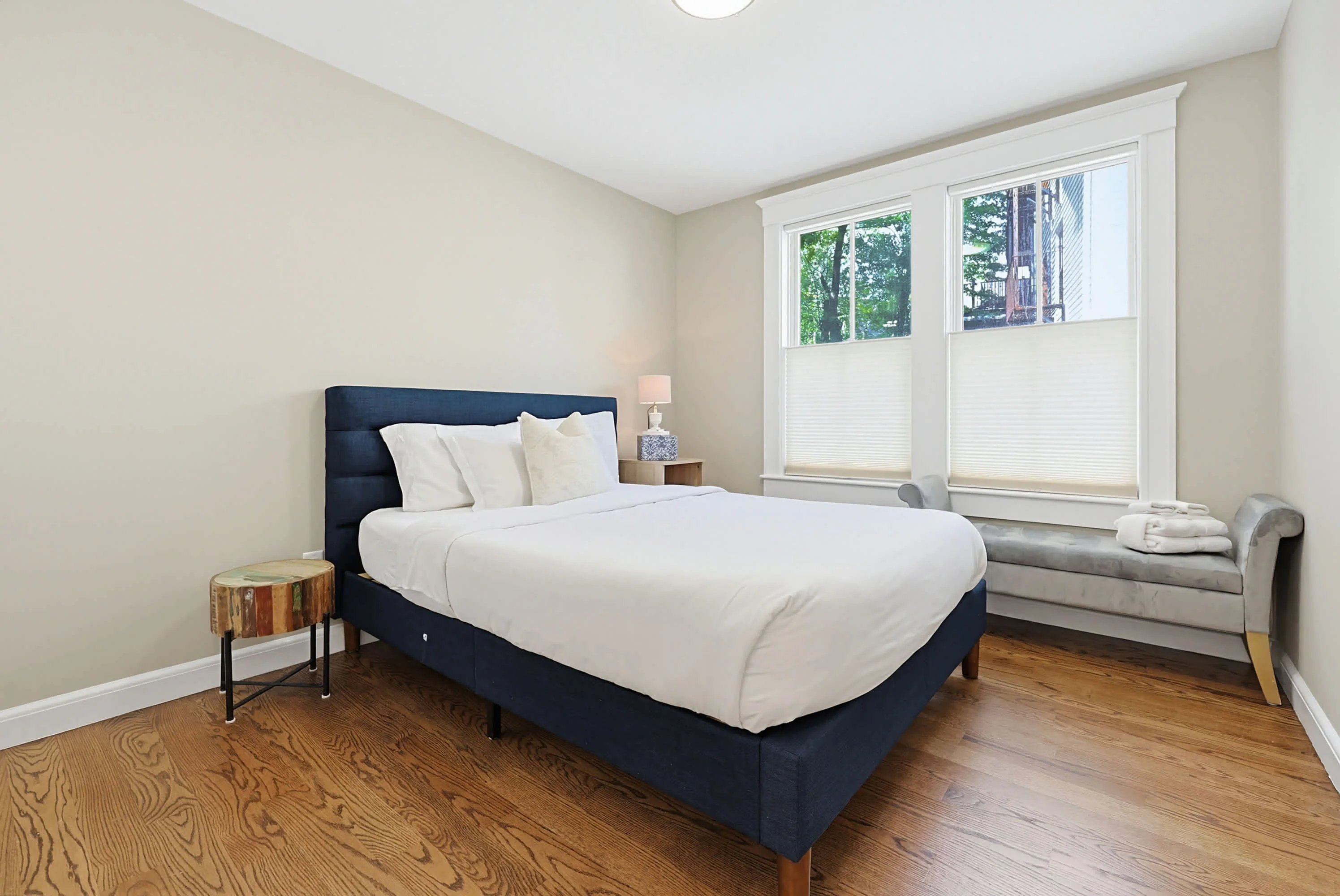 Modern bedroom with navy bed and hardwood floors in Cambridge vacation rental
