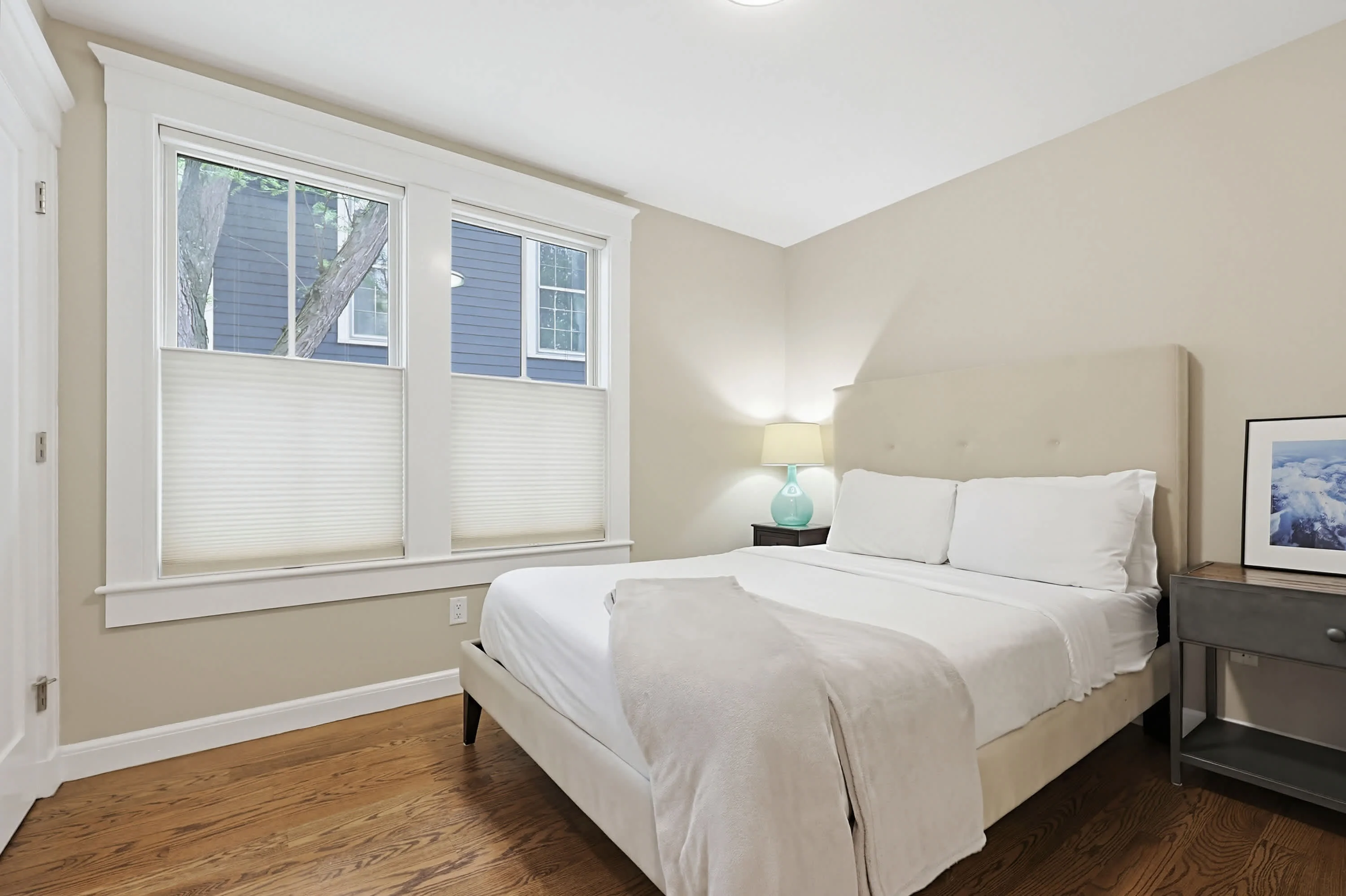 Bright queen bedroom with white linens, a stay option for where to stay in Cambridge