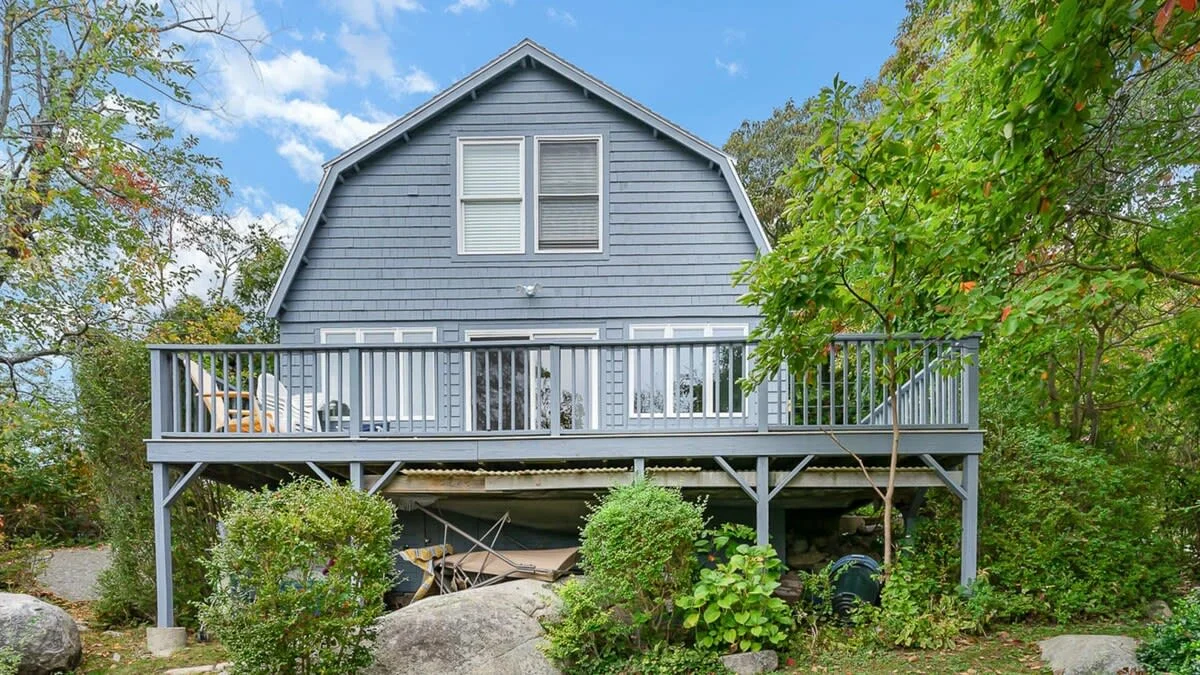 Modern gray raised beach house with wrap-around deck at Good Harbor Beach, Gloucester MA