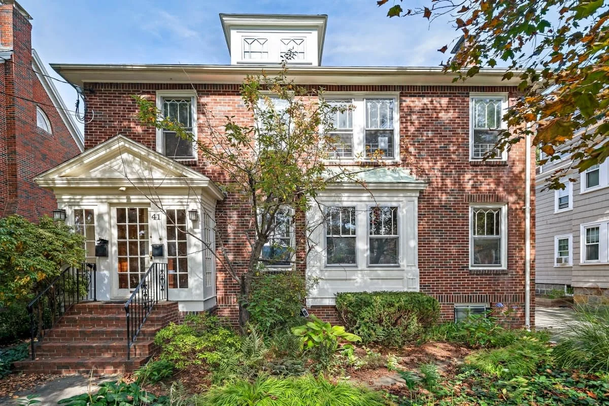 Red brick Boston brownstone with white trim and historic architecture epitomizing Boston neighborhoods in South End