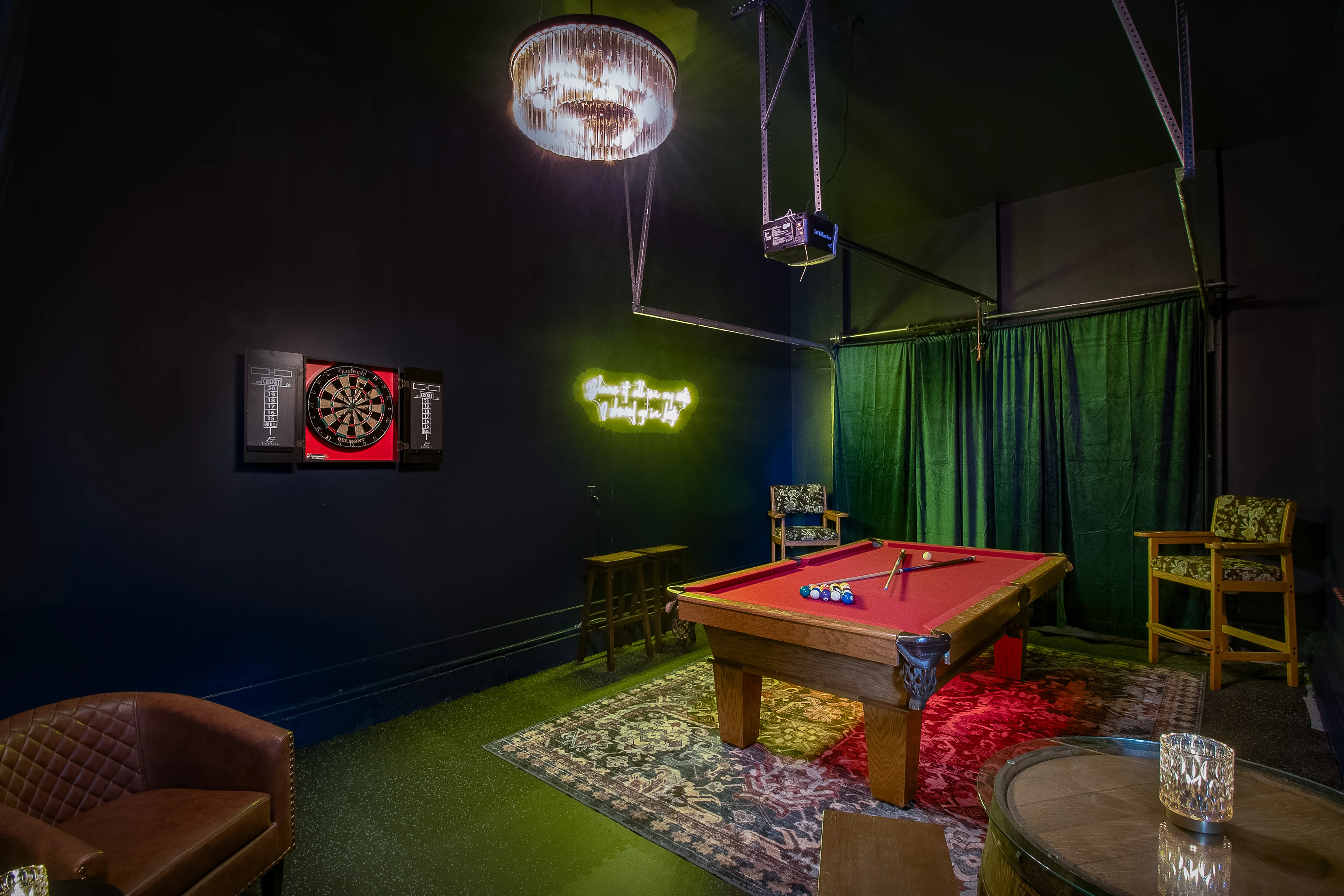 Game room with billiards table and neon signage offering live entertainment options in Nashville