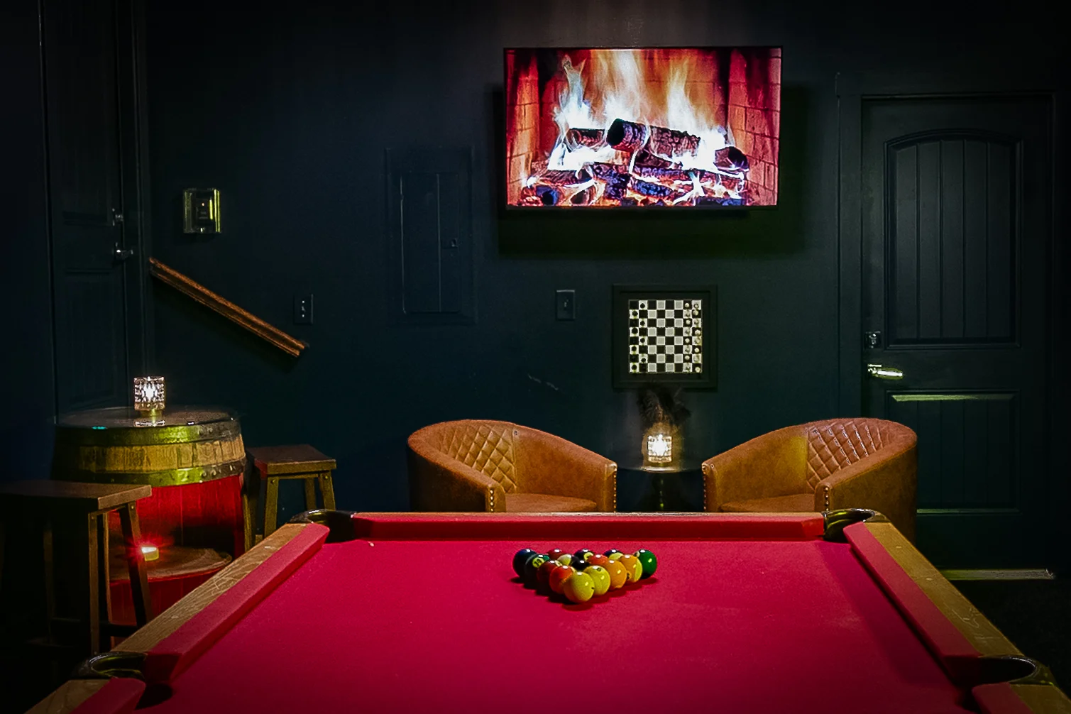 Luxury short term rental Nashville TN entertainment room with pool table, fireplace, and leather seating for guests