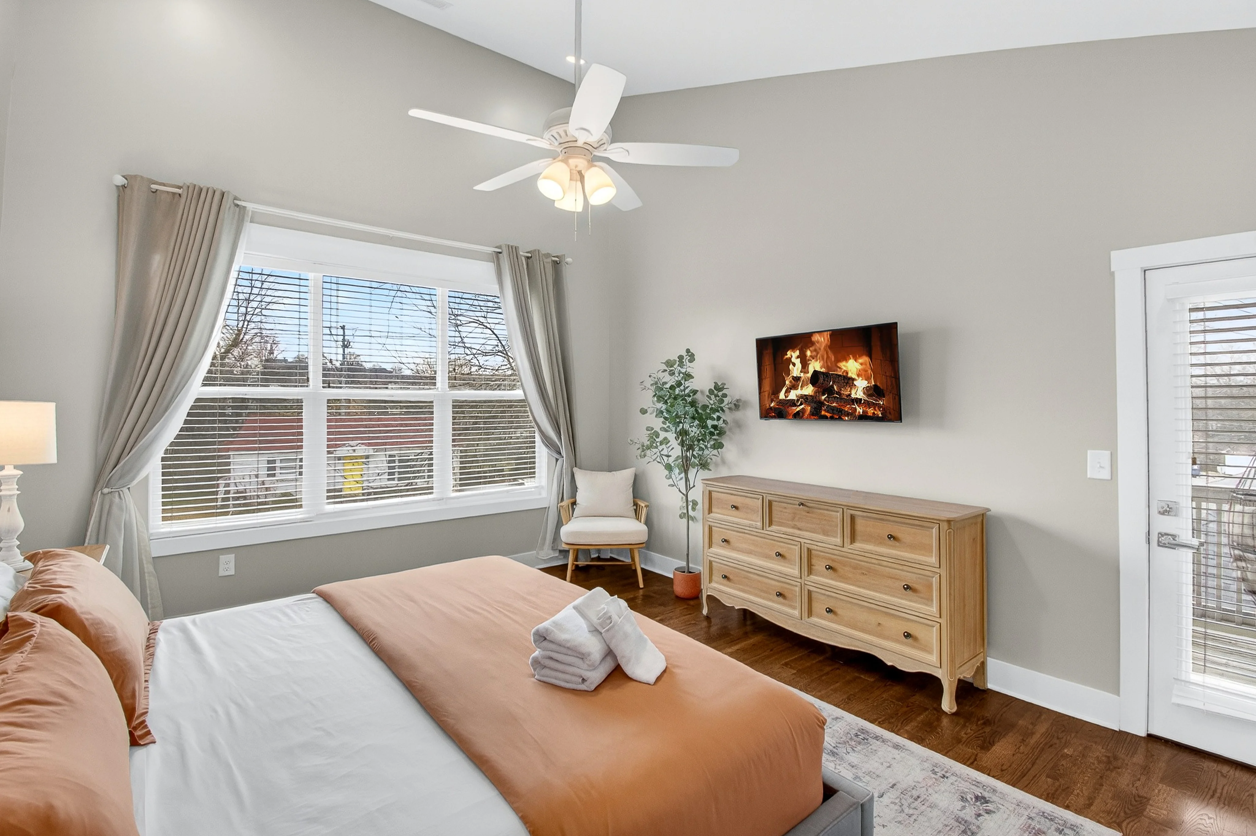 Modern master bedroom with large windows, fireplace, and natural light at Underwood Manor Nashville historic property