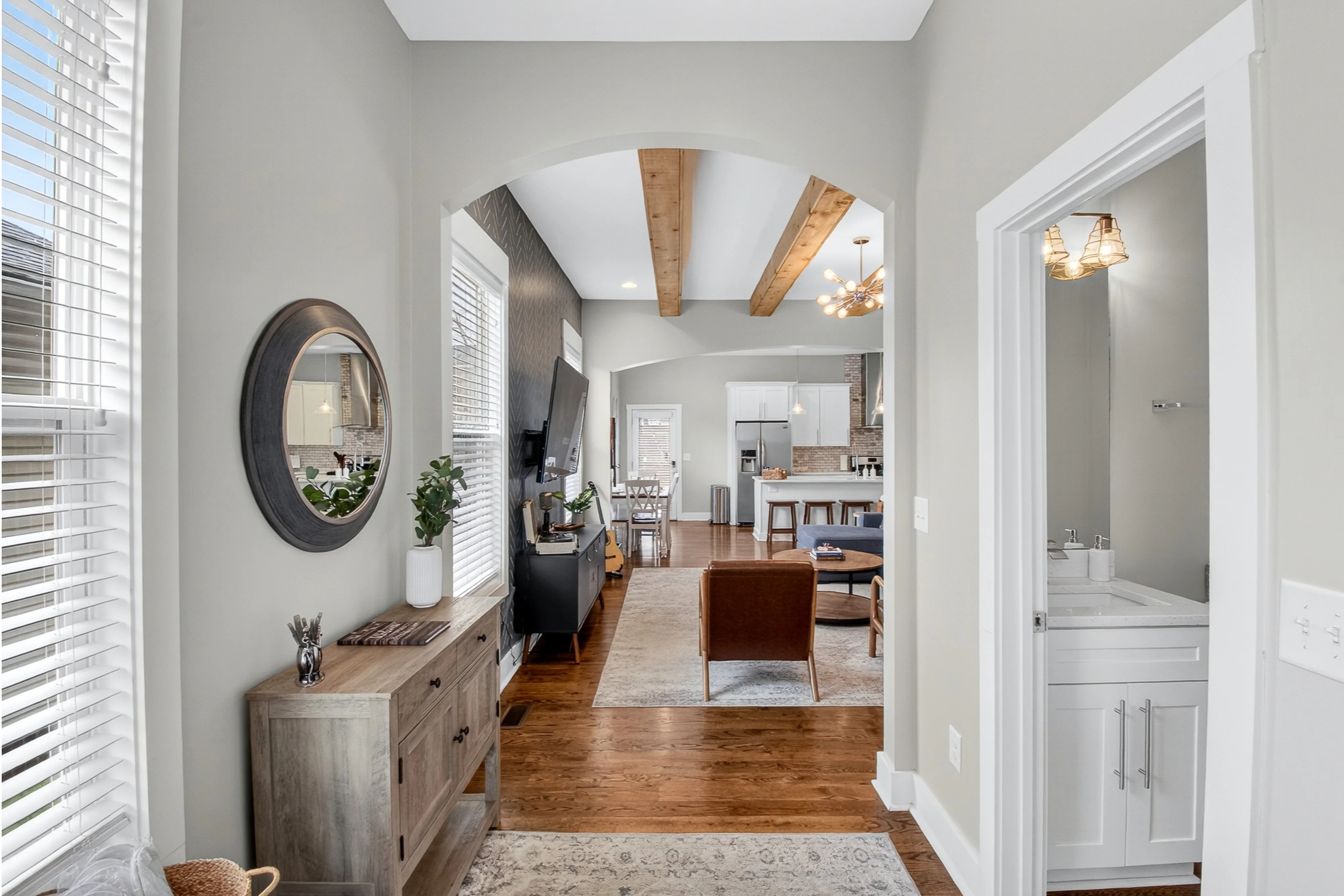 Modern entryway with hardwood floors and wooden beams at Underwood Manor in Nashville, Tennessee