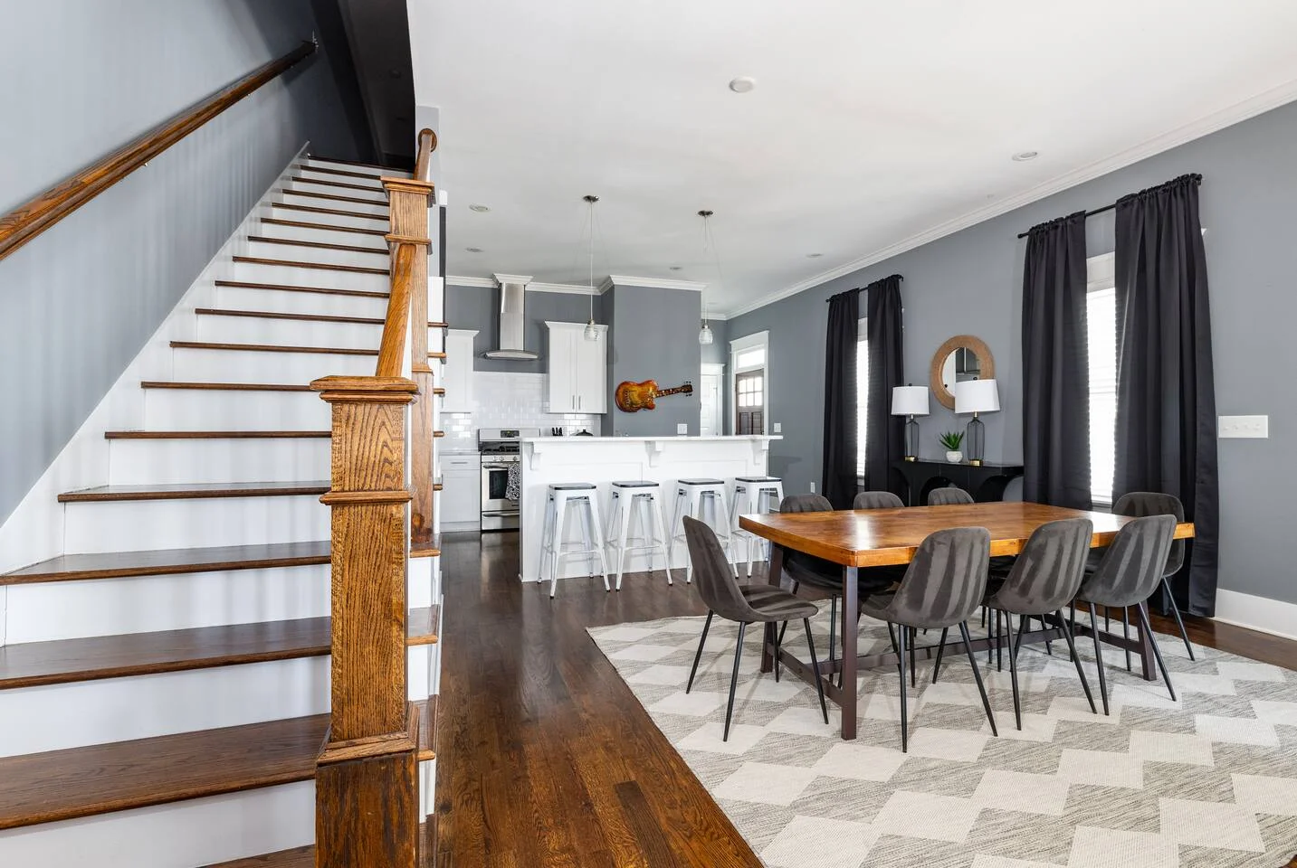 Modern open-concept living space with kitchen and dining area in Nashville bachelor party house