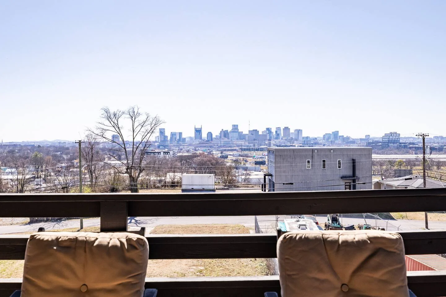 Elevated patio with tan seating overlooking Nashville skyline in modern vacation rental