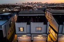 Modern rooftop with illuminated windows and city skyline at golden hour in Nashville