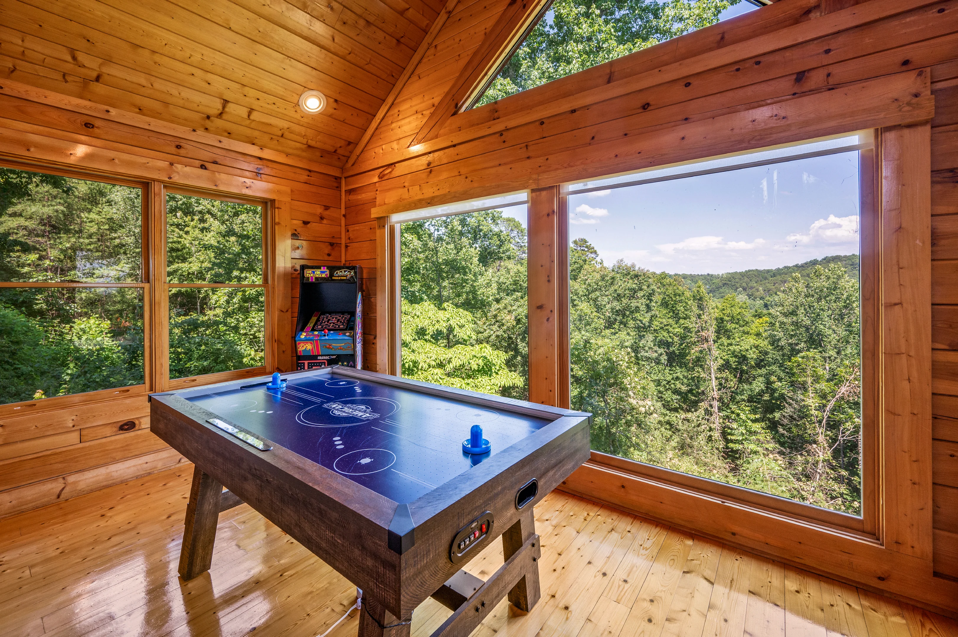 Game room with air hockey and mountain views in a private pool cabin in Sevierville TN