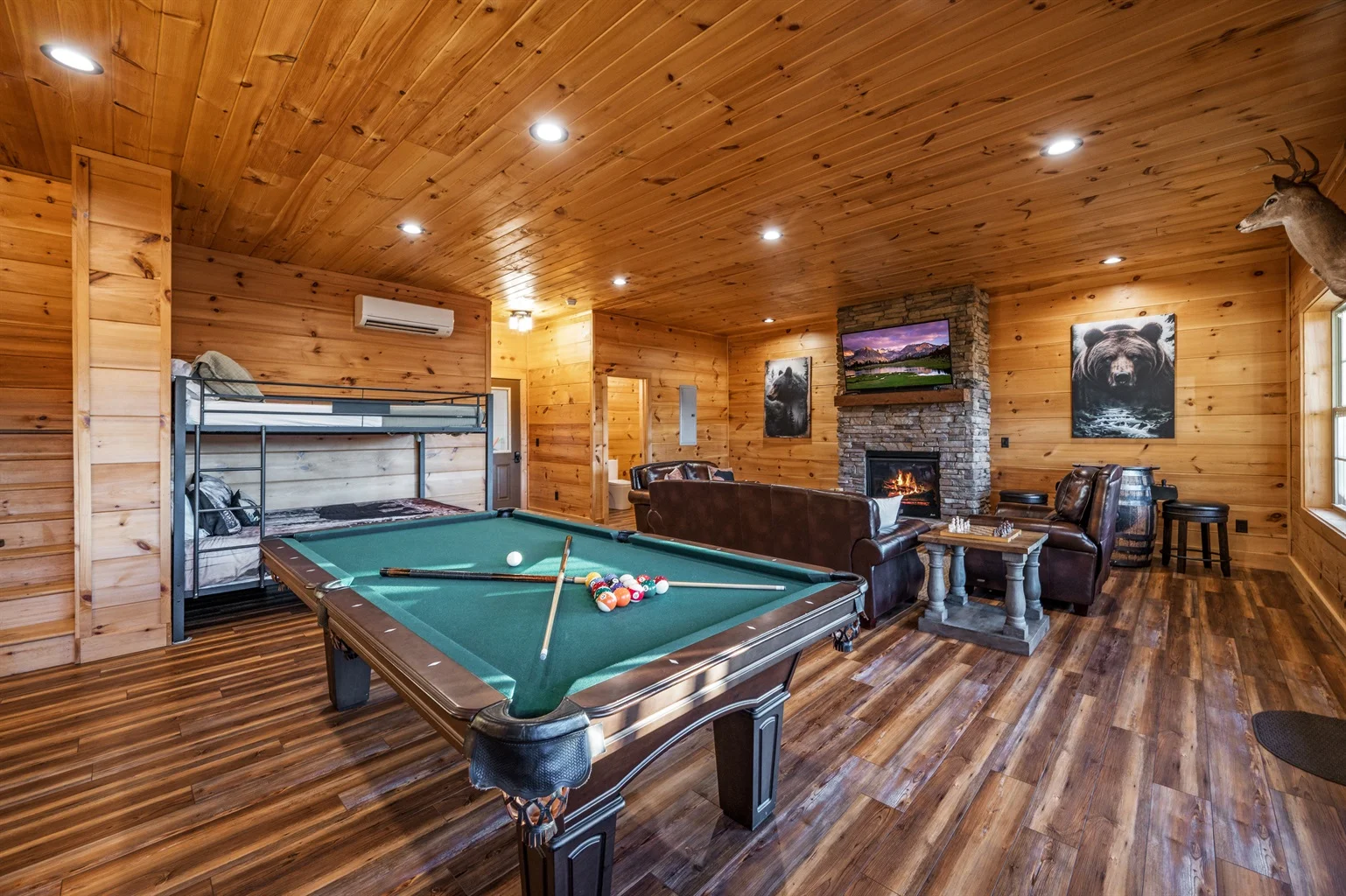 Professional Smoky Mountain property management luxury game room with pool table and golf simulator overlooking scenic