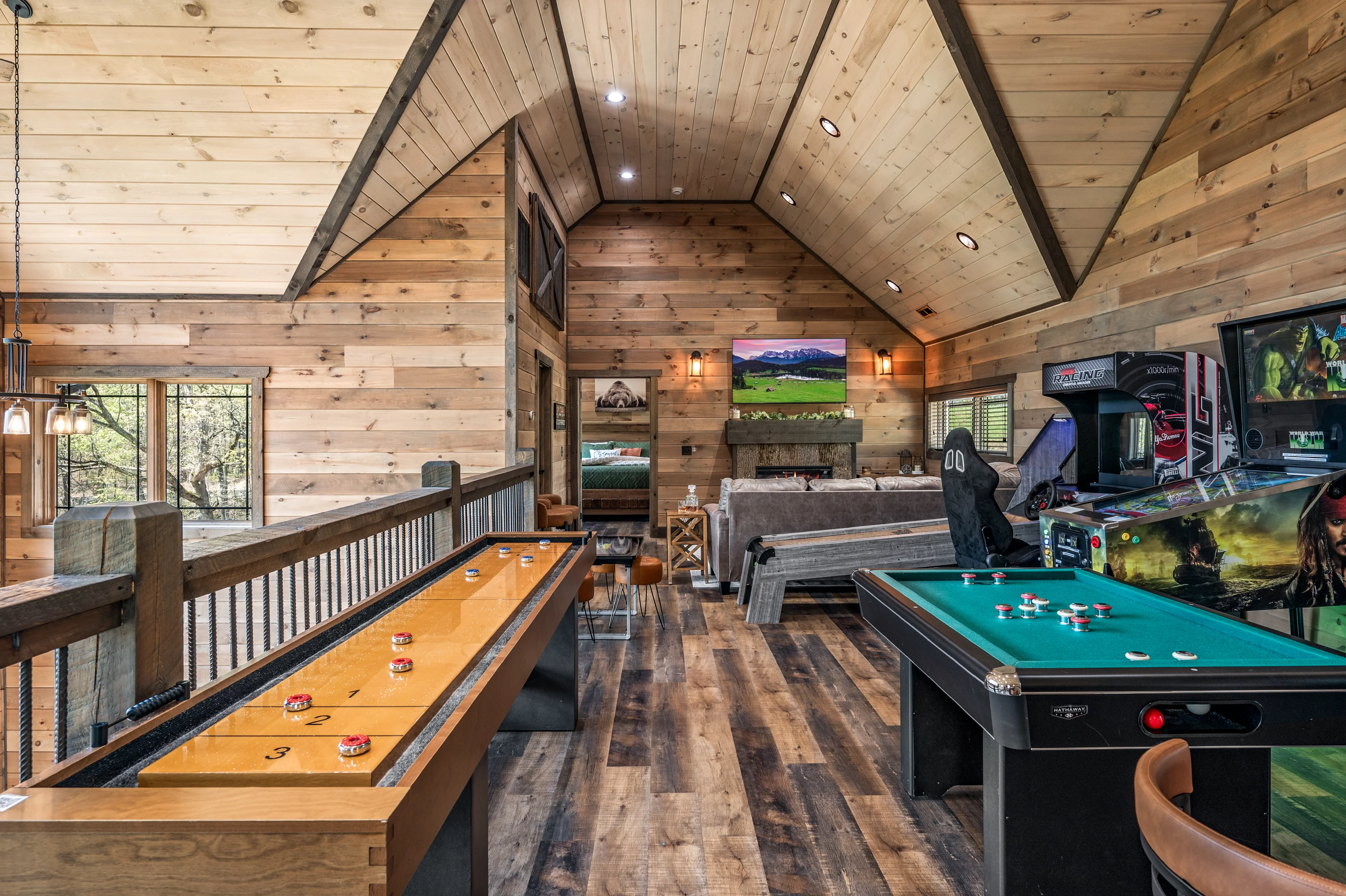 Game room with pool table, shuffleboard, and arcade games in Sevierville TN log cabin