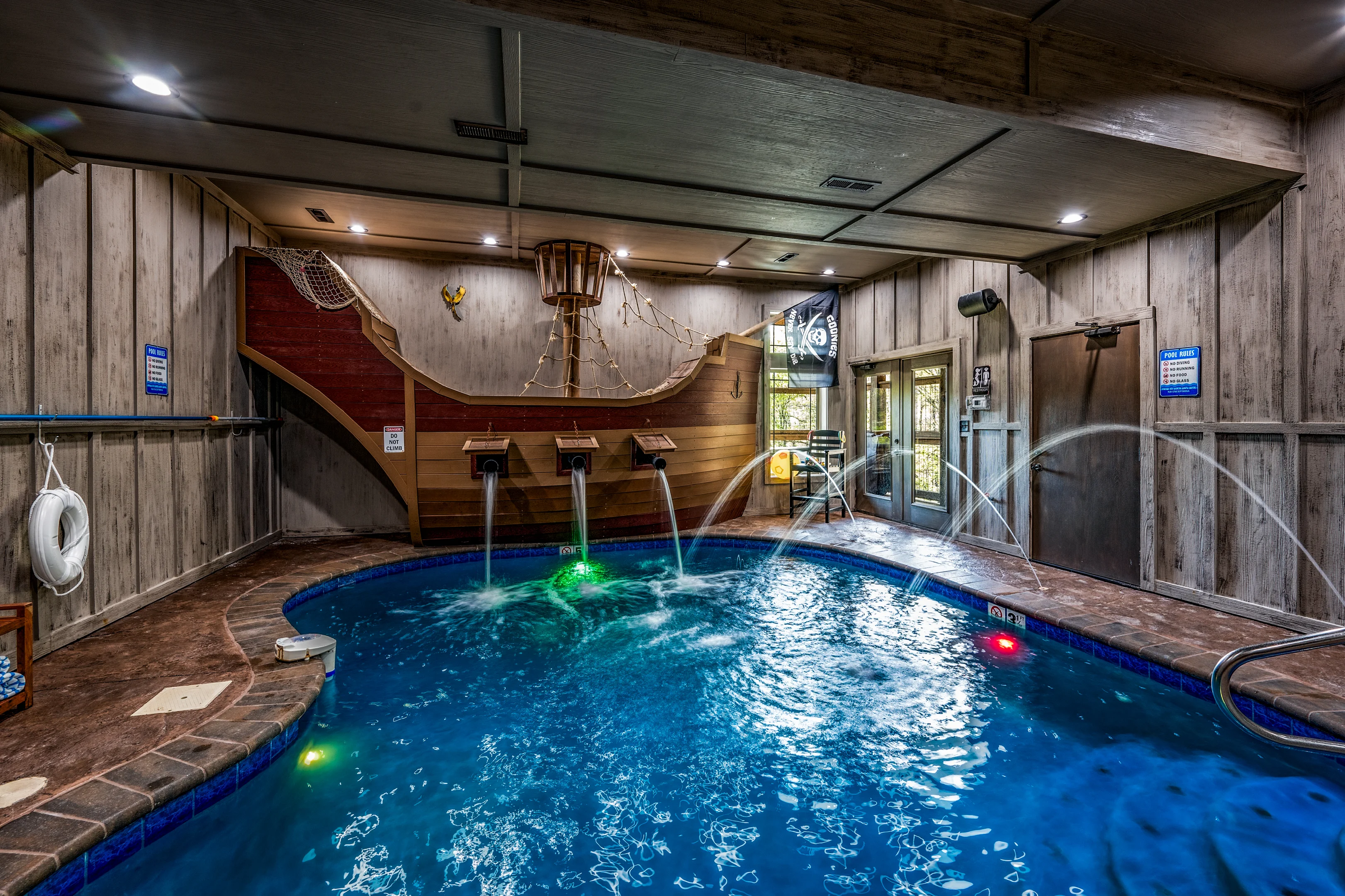 Modern luxury deck with hot tub and sauna overlooking forested mountains in Pigeon Forge cabin rental