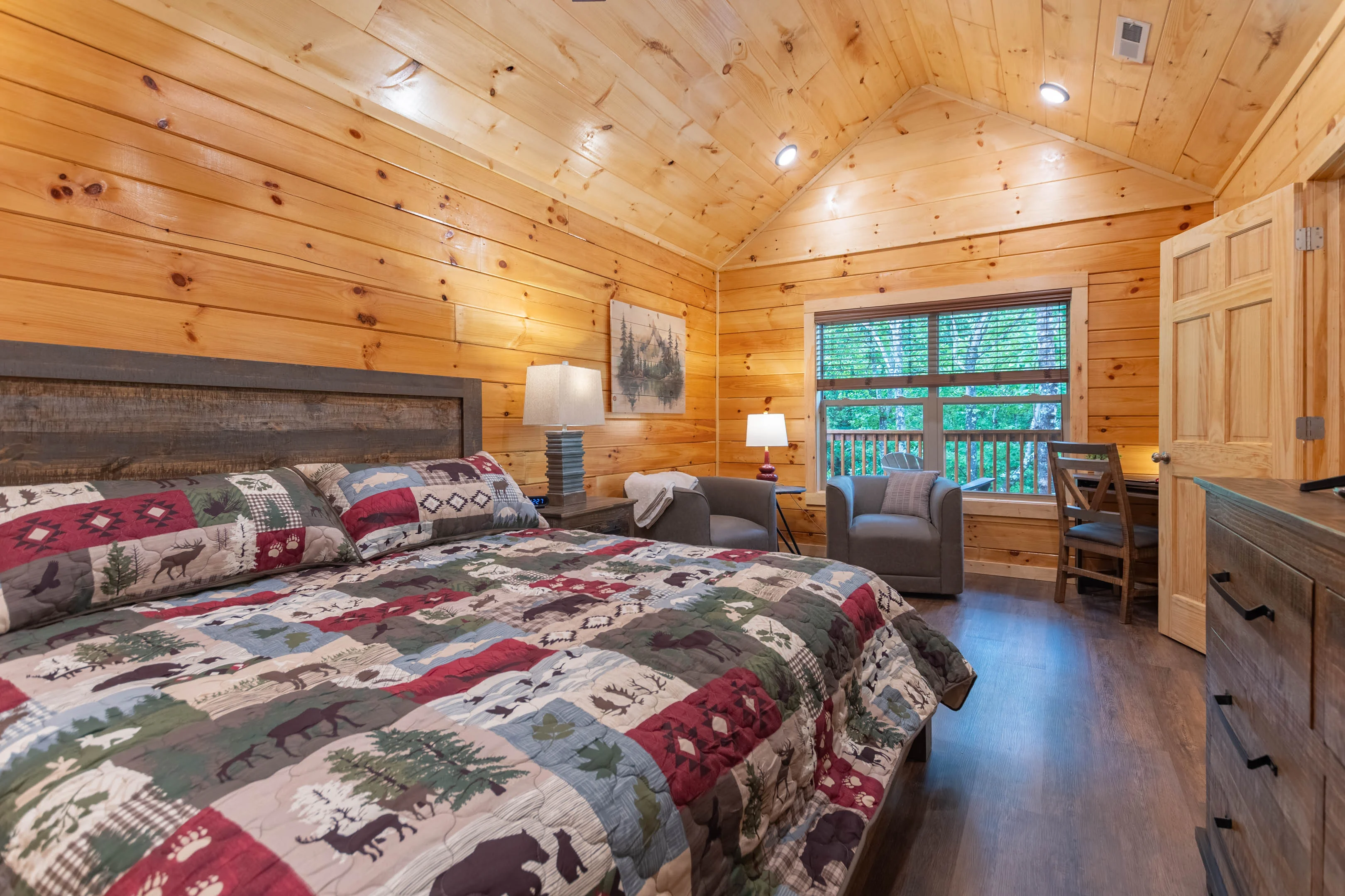 Luxury cabin bedroom with king bed and forest views showcasing premium vacation rental amenities in Pigeon Forge Tennessee