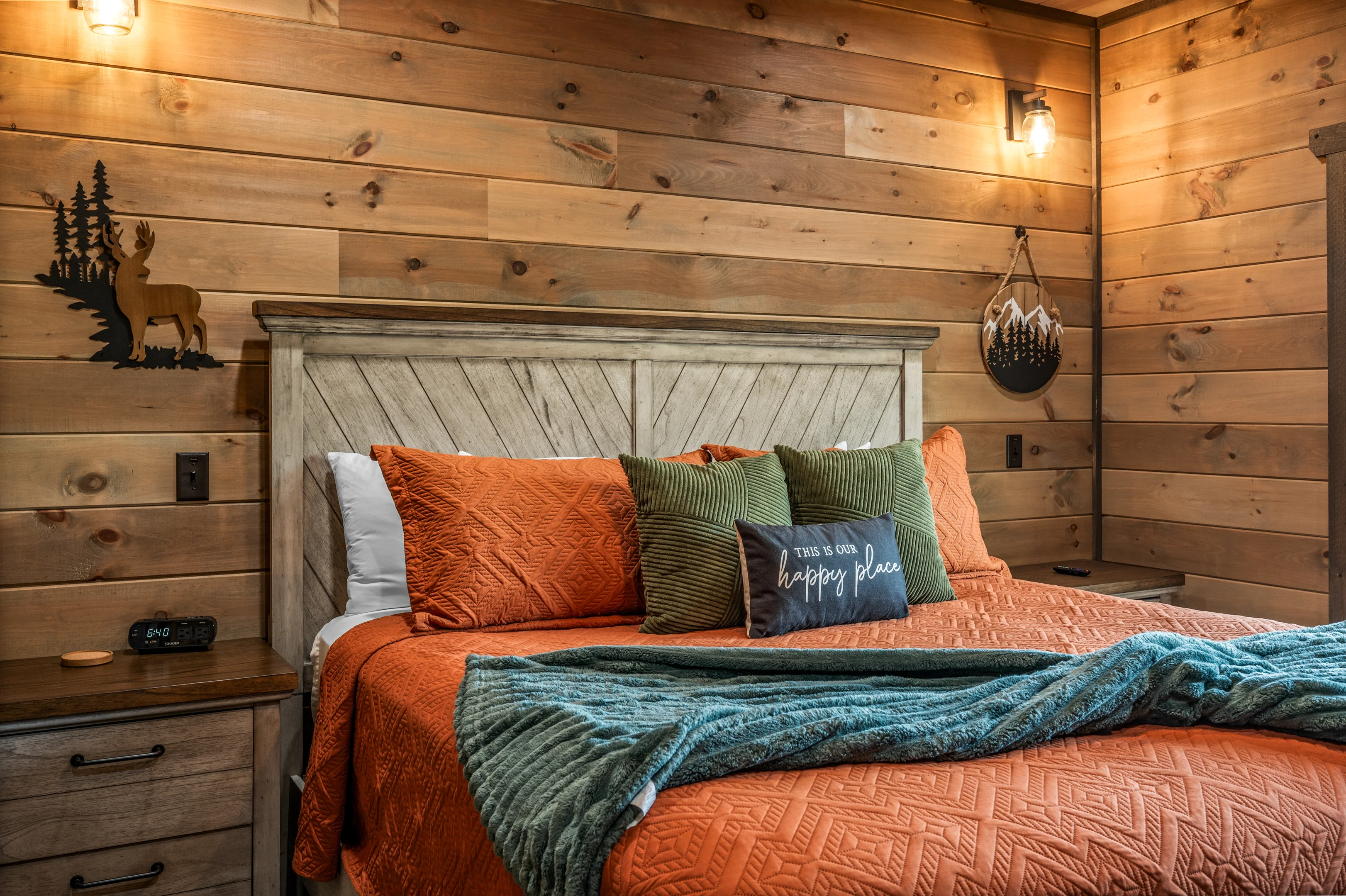 Cozy rustic log cabin bedroom with forest-themed decor in Sevierville cabin