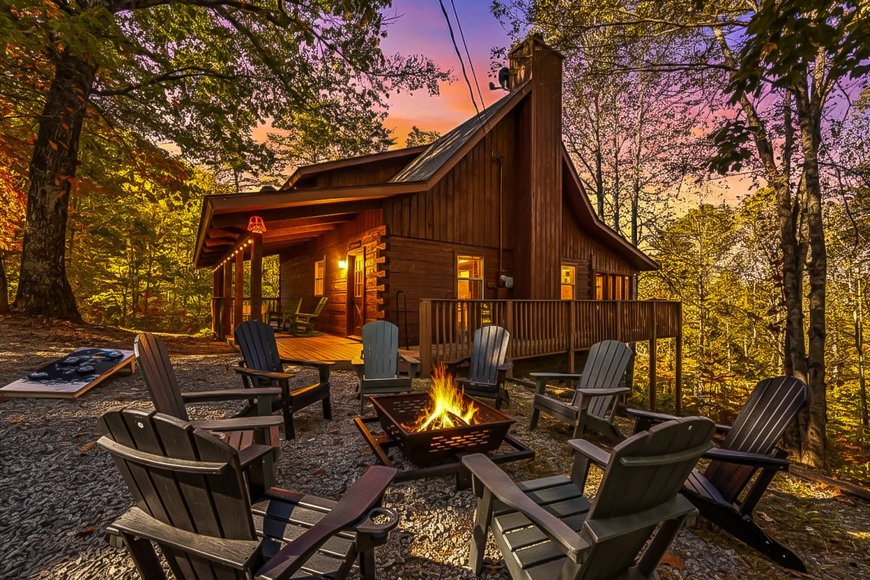 Rustic log cabin in Great Smoky Mountains with fire pit and Adirondack chairs at twilight, perfect base for secret waterfall