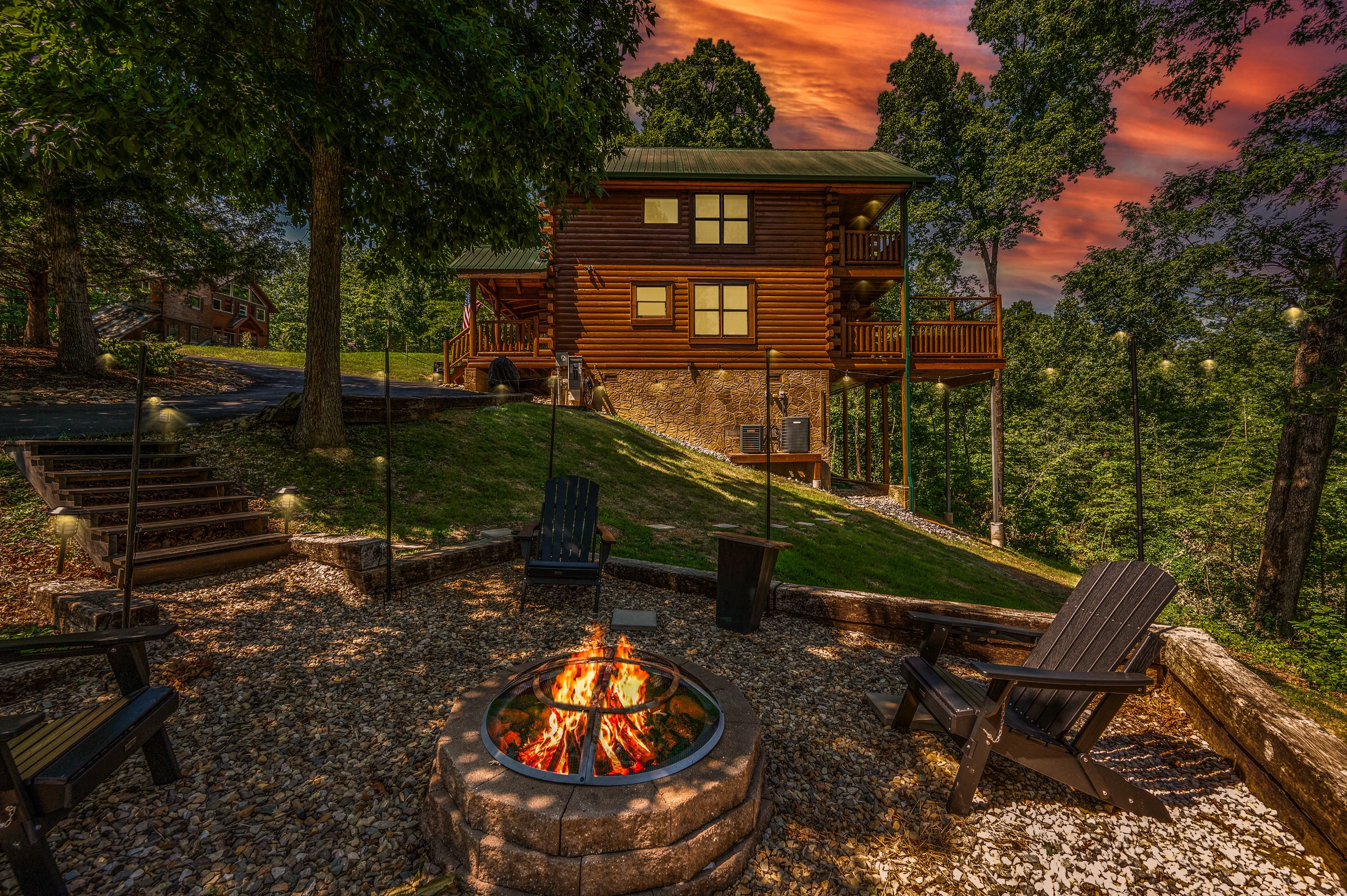 Rustic log cabin with private firepit and Adirondack chairs at sunset, ideal base for Pigeon Forge TN family activities
