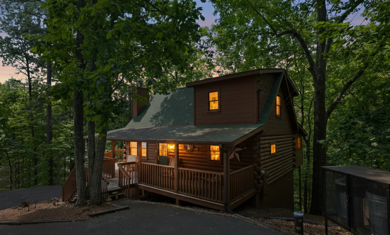 Luxury family reunion cabin exterior at twilight with wraparound deck in Tennessee mountains