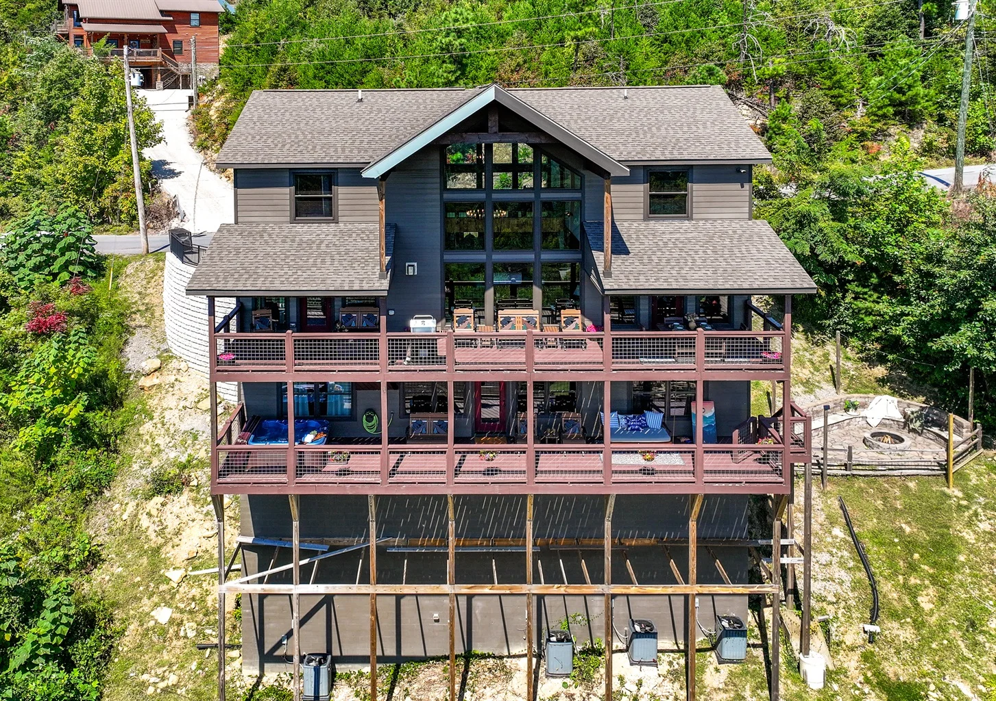 Modern Gatlinburg vacation rental exterior with multi-level deck, luxury amenities, and forest views showcasing contemporary