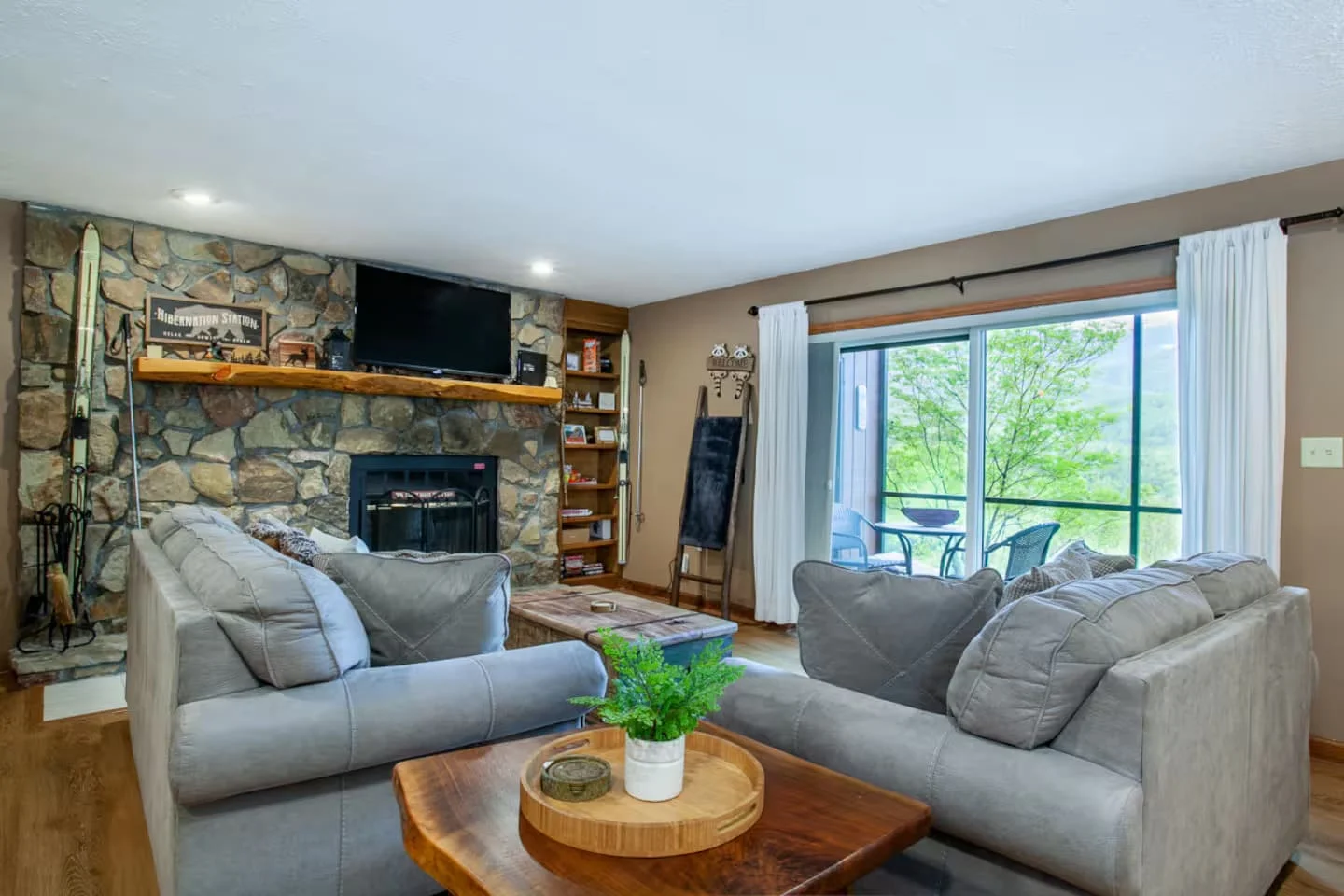 Gatlinburg February cabin rental living room with stone fireplace and mountain views