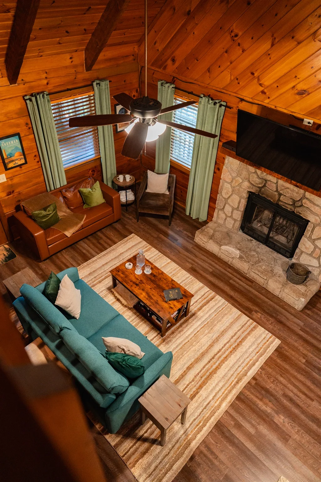 Spacious log cabin living room with vaulted ceilings, stone fireplace, and comfortable seating ideal for Pigeon Forge