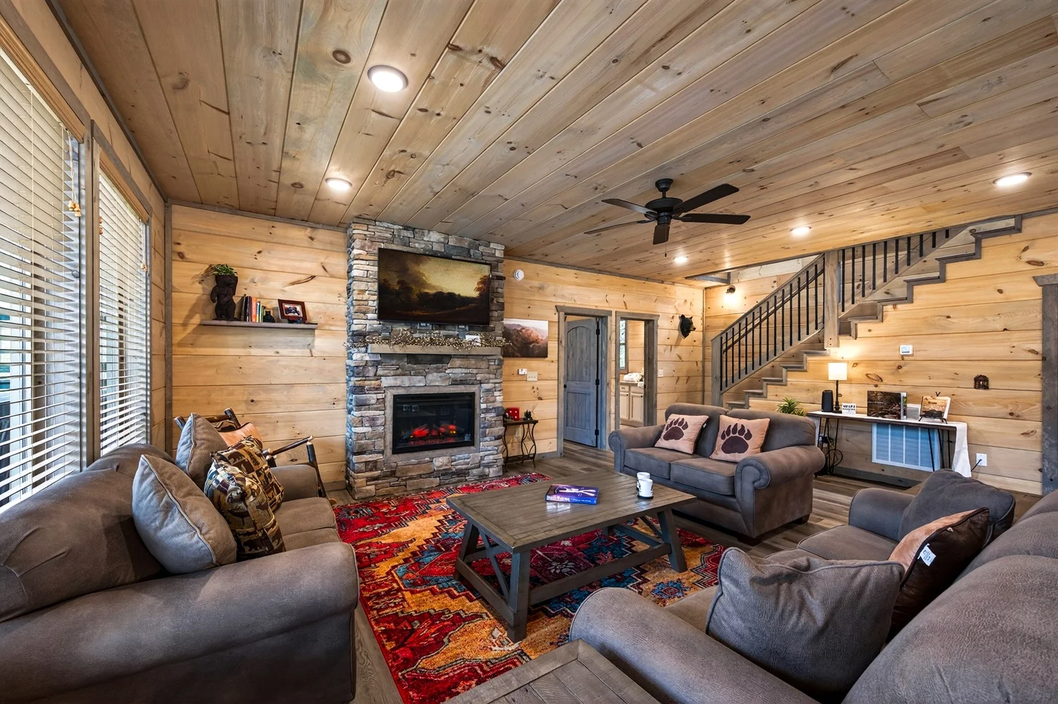 Romantic cabin living room with stone fireplace and mountain views perfect for Tennessee couples getaway