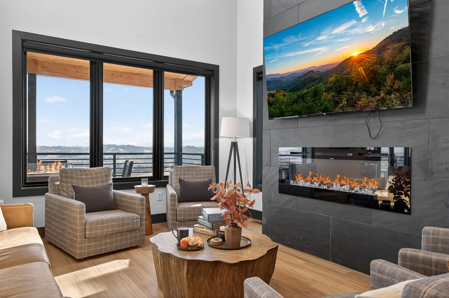 Luxury living room with floor-to-ceiling windows overlooking Smoky Mountains, featuring modern fireplace and contemporary