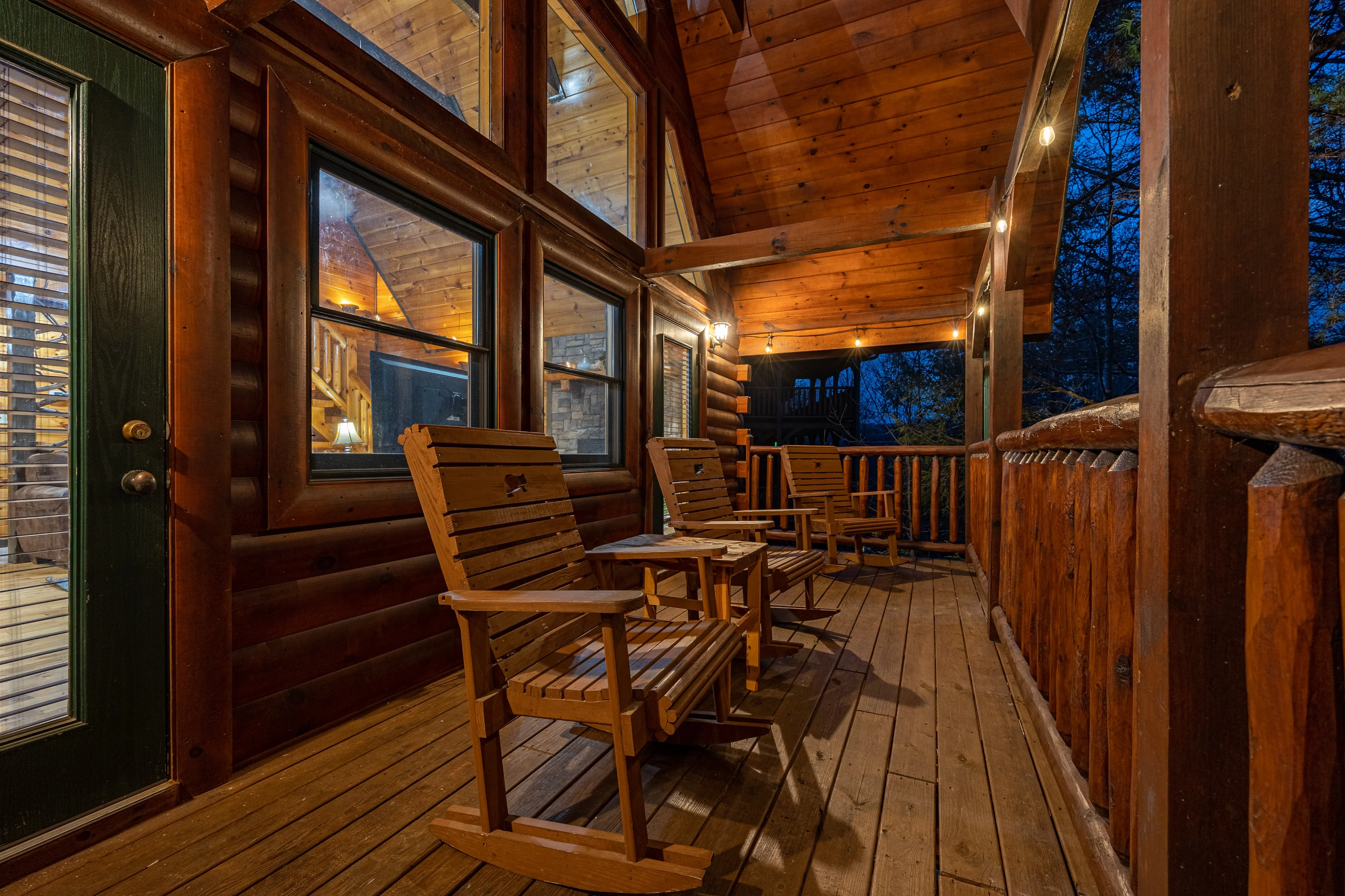 Covered cabin porch with Adirondack chairs at dusk, ideal base for Pigeon Forge adult nightlife