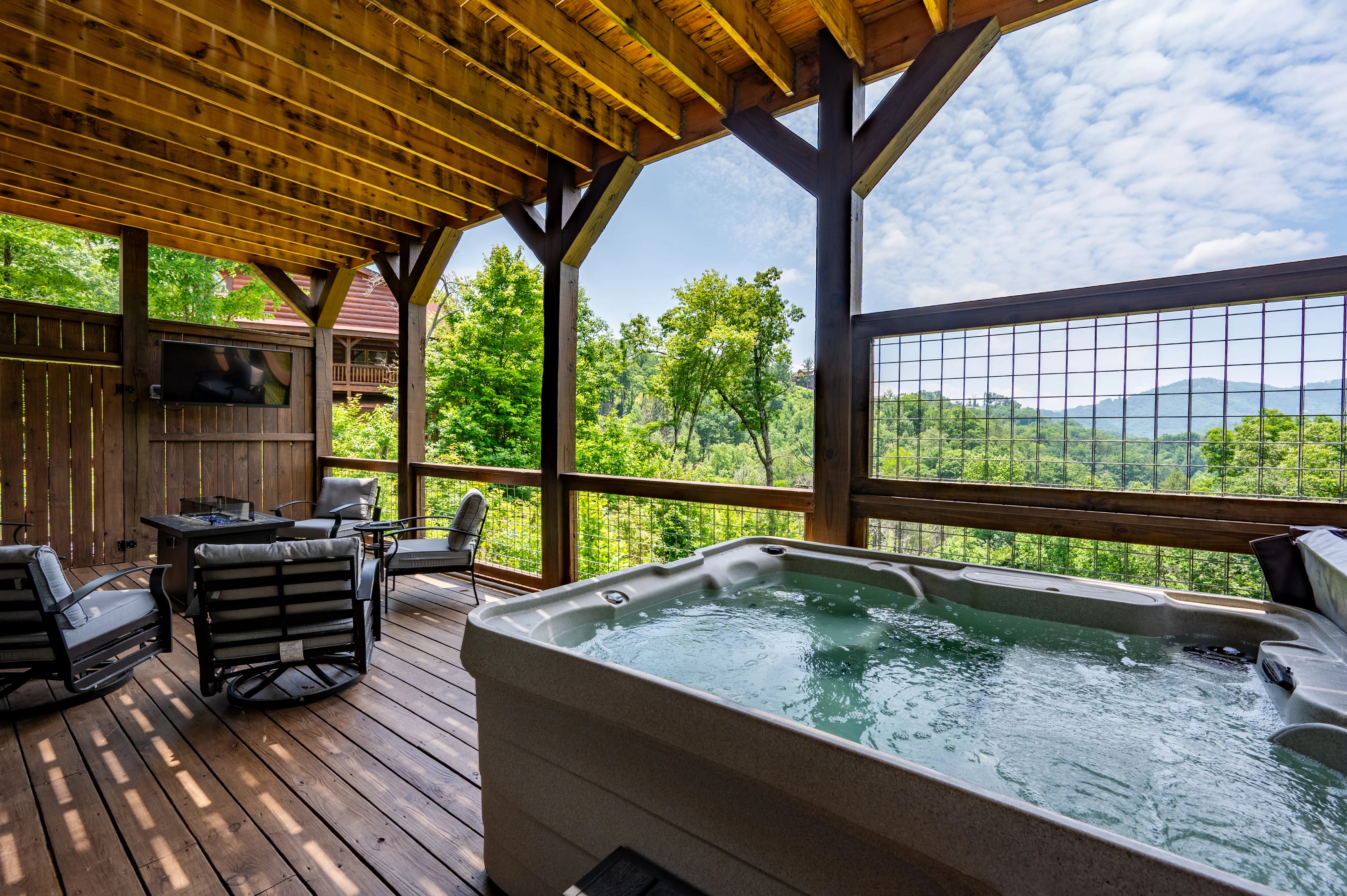 Covered deck with hot tub overlooking panoramic mountain views from Smoky Mountain hiking trails near Sevierville