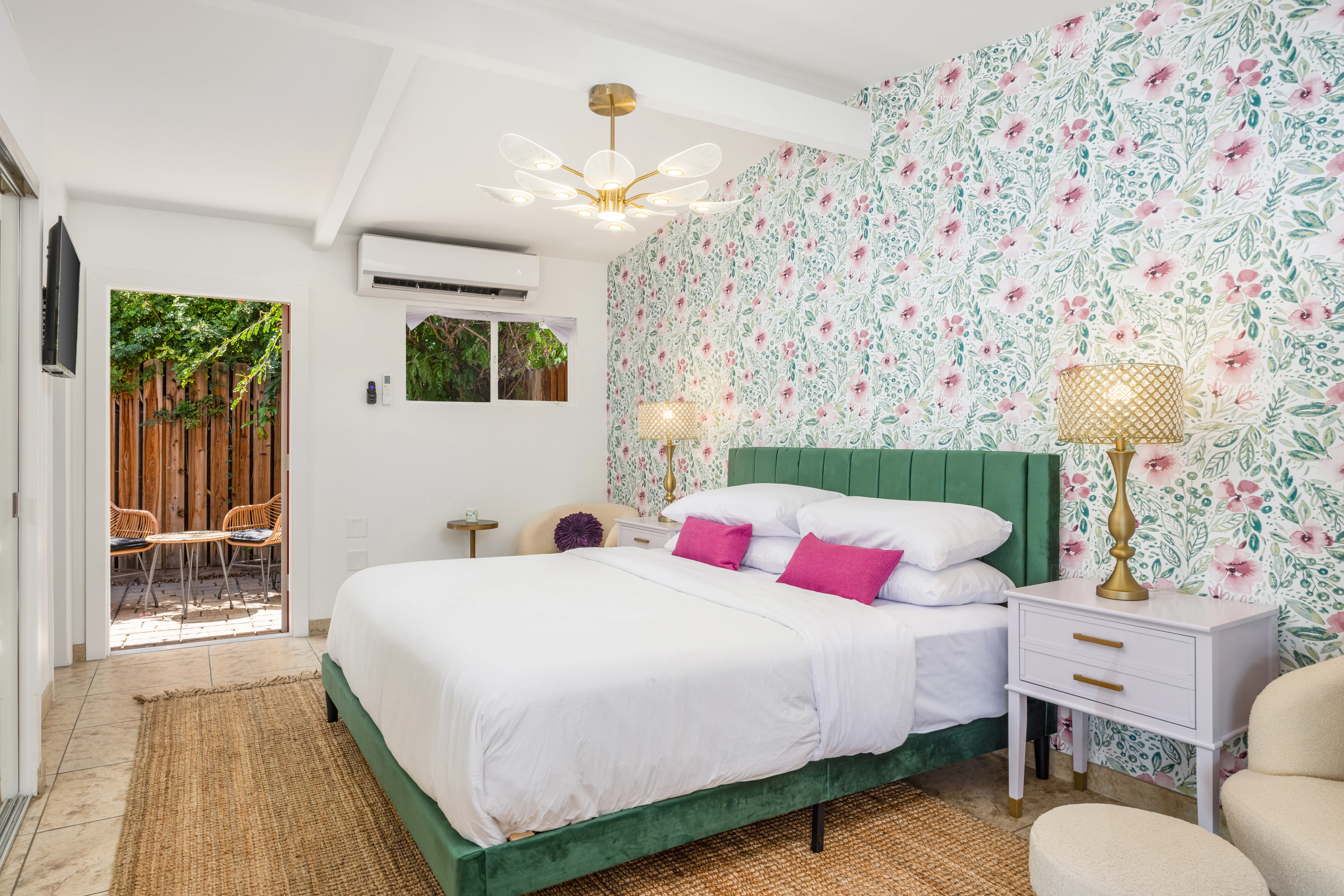 Luxury bedroom with green velvet bed and patio access at dog friendly hotel in Palm Springs