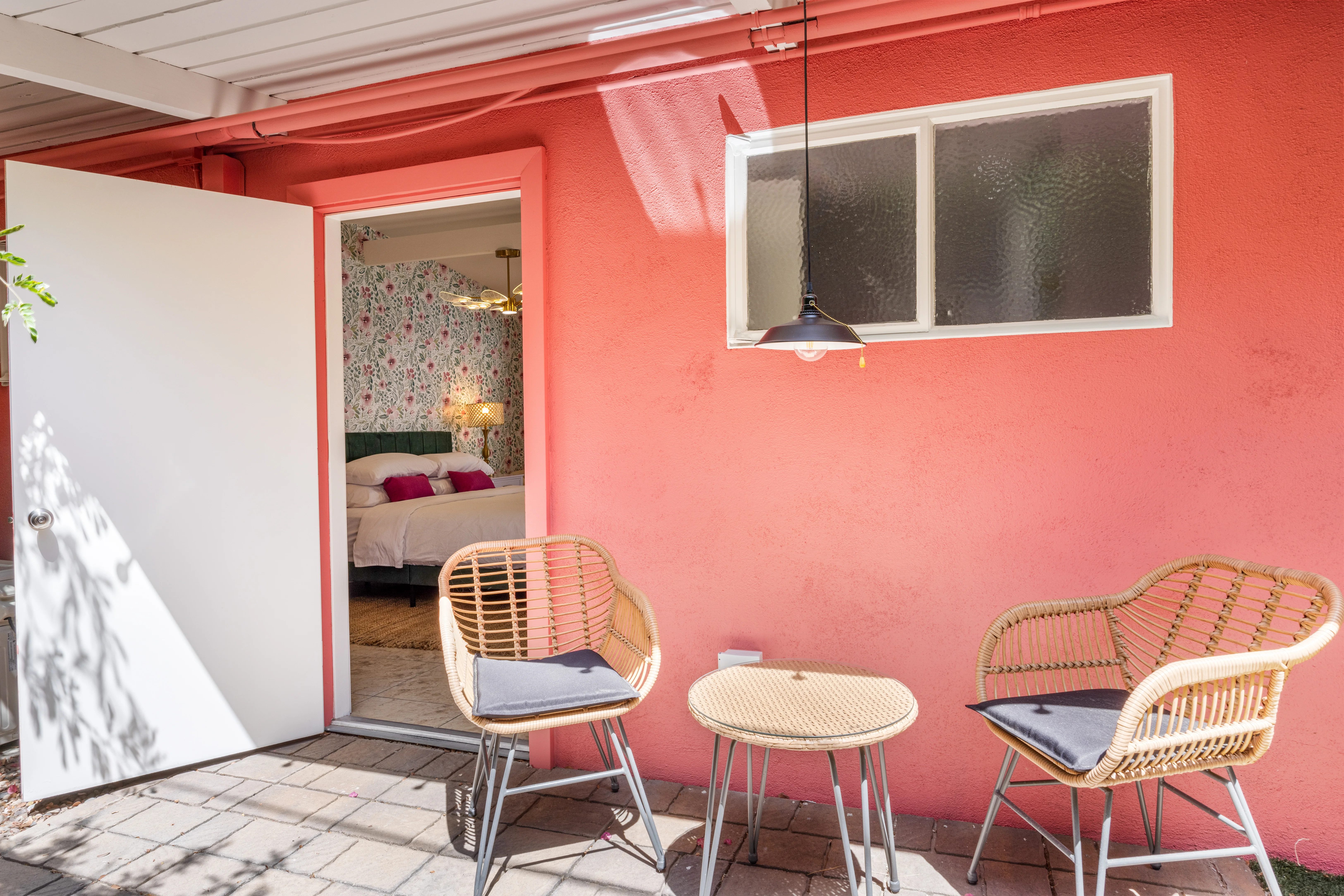 Coral pink entrance of a dog friendly hotel suite in Palm Springs with private backyard access