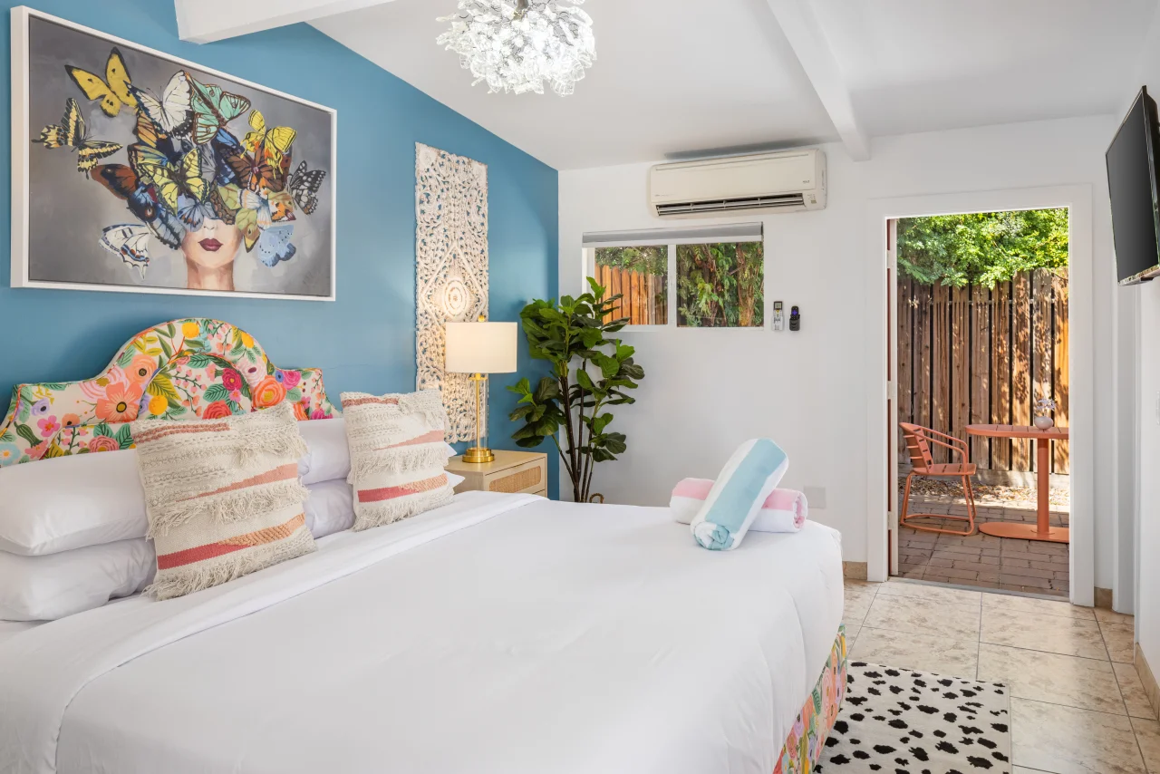 Bright bedroom with floral headboard perfect for couples massage Palm Springs CA getaway